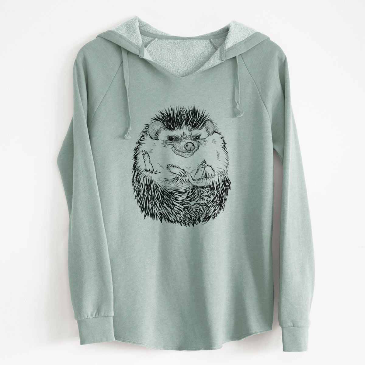 Sage green women's Cali Wave hooded sweatshirt laid flat, printed with a detailed black ink illustration of a hedgehog curled up and facing forward.