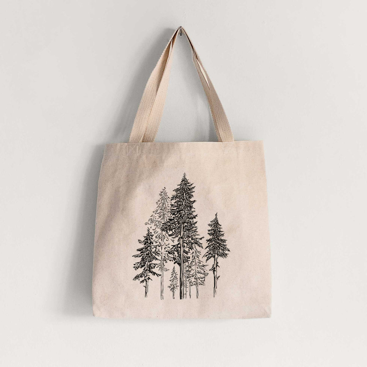 Natural canvas tote bag printed with a black ink illustration of a forest of tall hemlock trees.