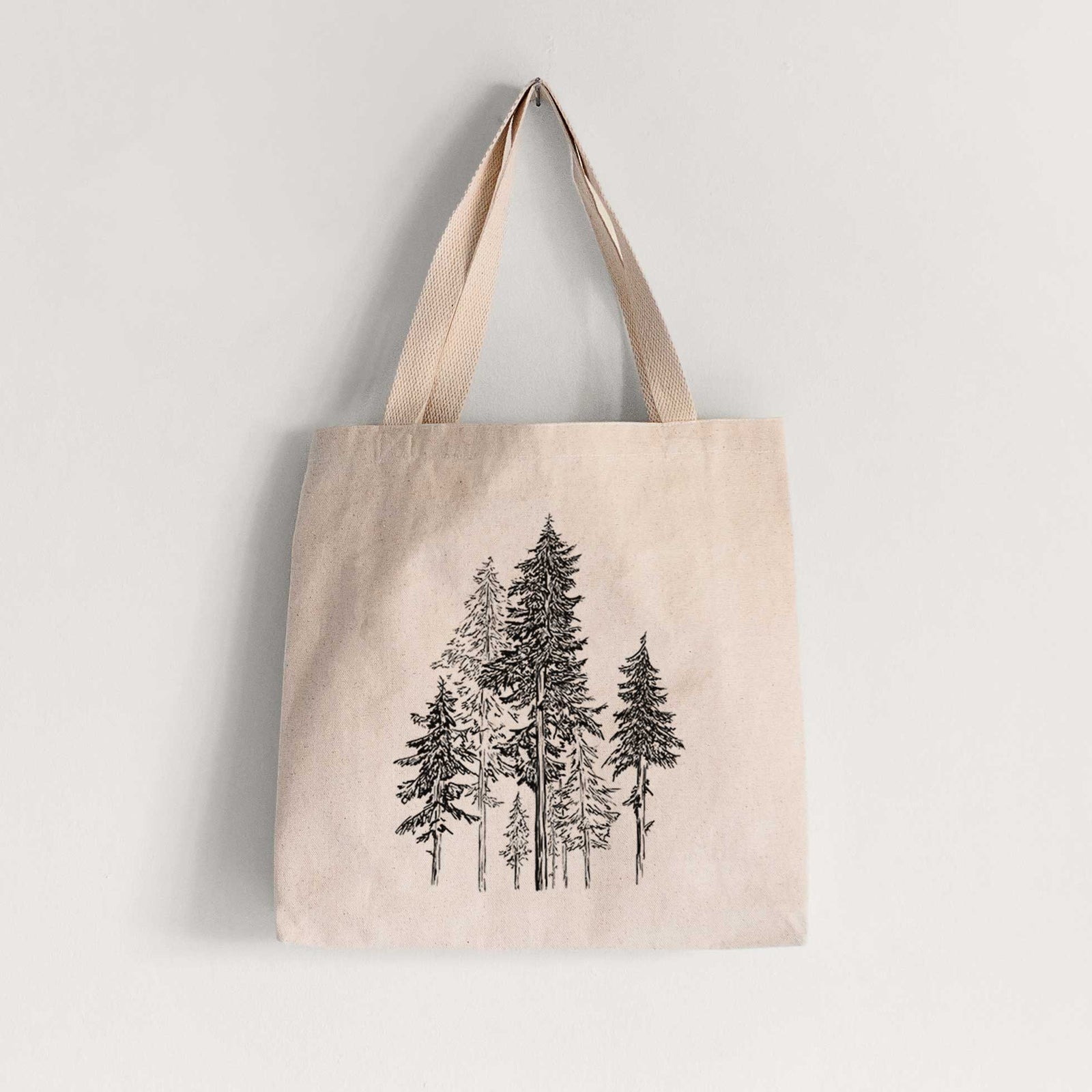 Natural canvas tote bag printed with a black ink illustration of a forest of tall hemlock trees.