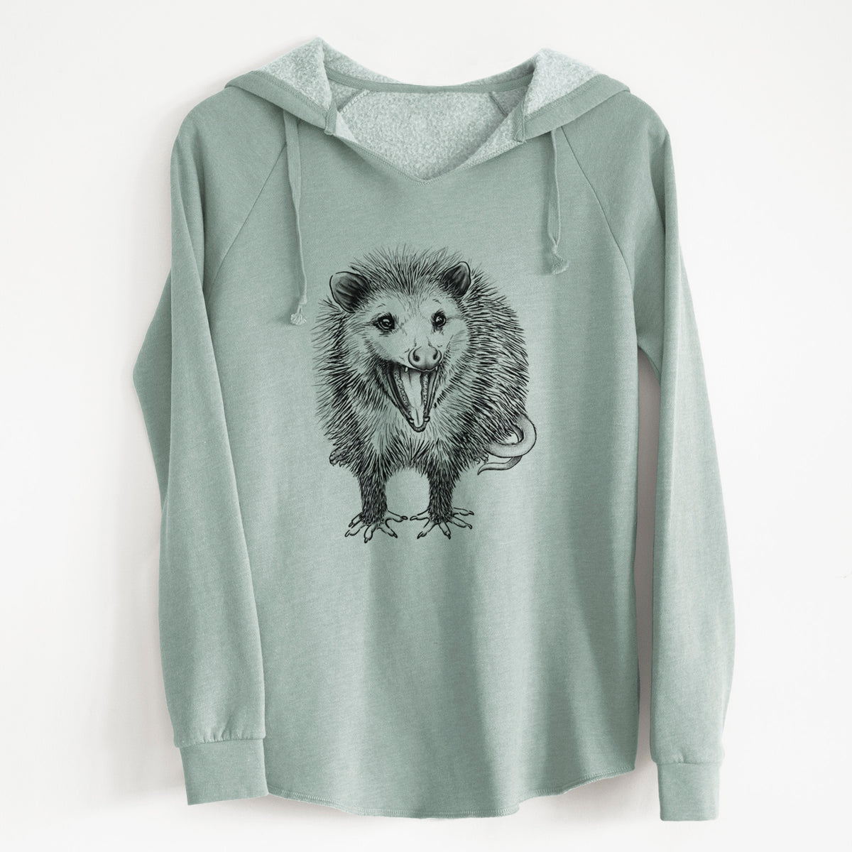 Sage green women's Cali Wave hooded sweatshirt laid flat, with a crossover hood, drawcords and curved hem, printed with a detailed black ink illustration of an opossum standing and facing forward, mouth open wide in a hiss, with shaggy fur and its tail curled behind.