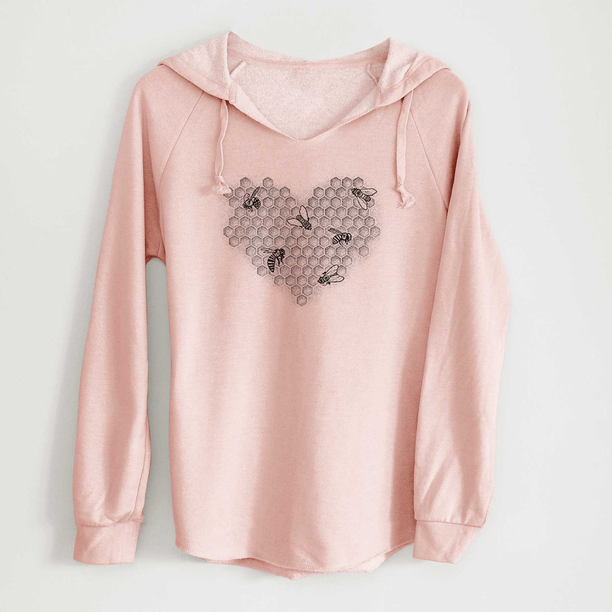 Blush pink women's Cali Wave hooded sweatshirt laid flat, printed with a black ink heart made of honeycomb cells with small bees crawling across it.