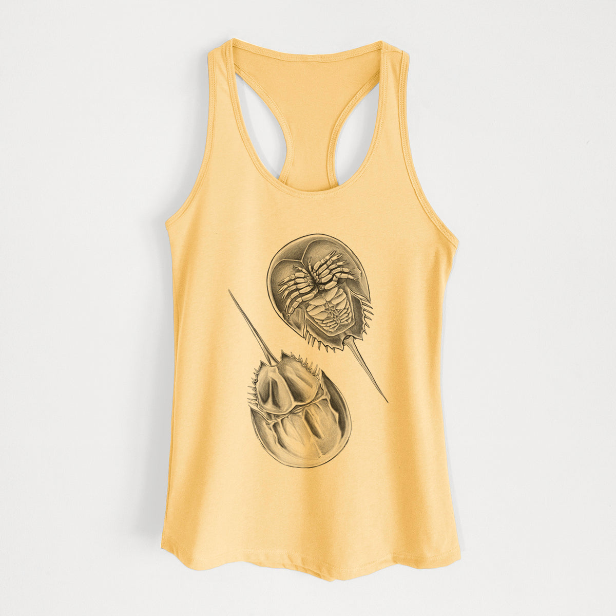 Banana cream women's racerback tank top laid flat, printed with a detailed black ink illustration of two horseshoe crabs.