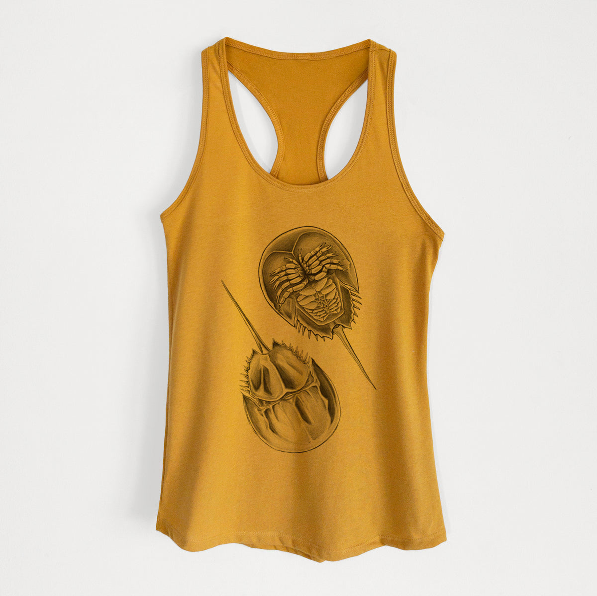 Gold women's racerback tank top laid flat, printed with a detailed black ink illustration of two horseshoe crabs.