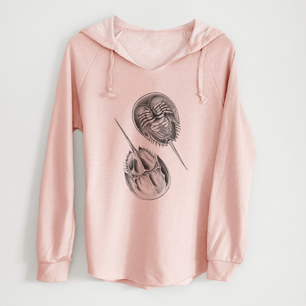 Blush pink women's Cali Wave hooded sweatshirt laid flat, printed with a detailed black ink illustration of two horseshoe crabs.