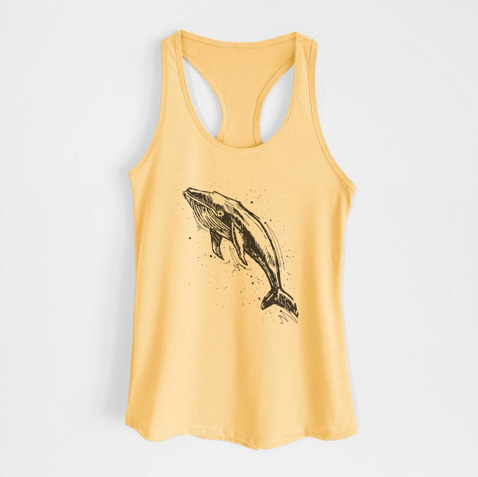 Banana cream women's racerback tank top laid flat, printed with a black ink illustration of a humpback whale diving, with ink splatters.