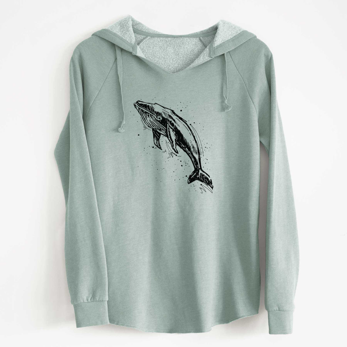 Sage green women's Cali Wave hooded sweatshirt laid flat, printed with a black ink illustration of a humpback whale diving, with ink splatters.