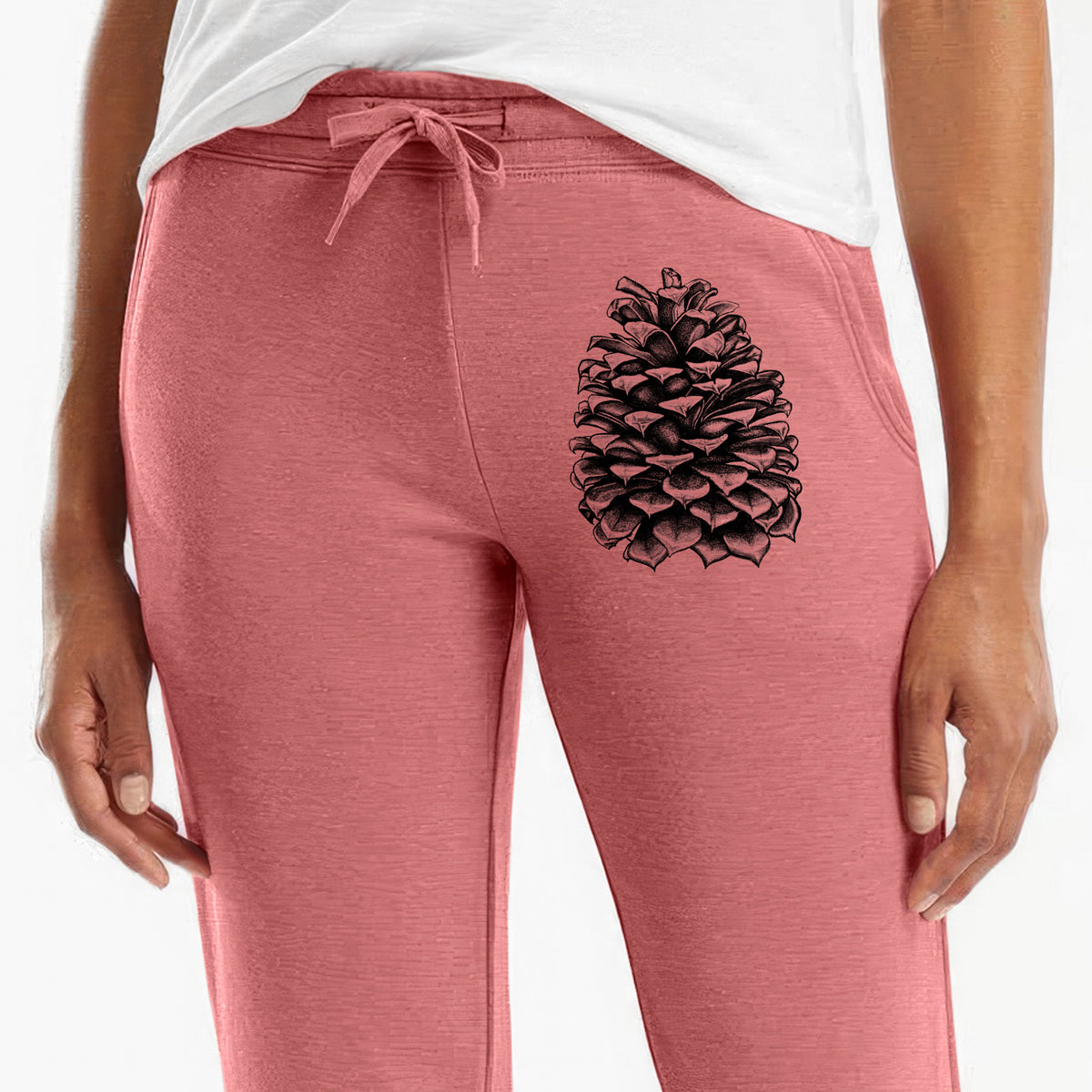 Front of dusty rose Cali Wave sweatpants, printed with a detailed black ink illustration of a large Jeffrey pine cone on the leg.