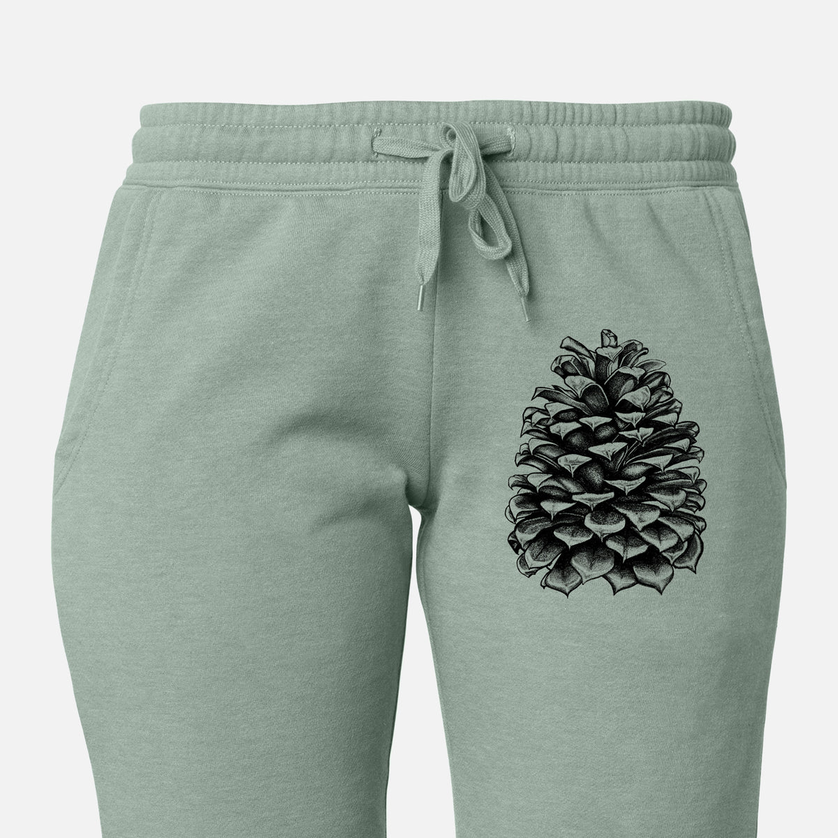 Front of sage green Cali Wave sweatpants, printed with a detailed black ink illustration of a large Jeffrey pine cone on the leg.