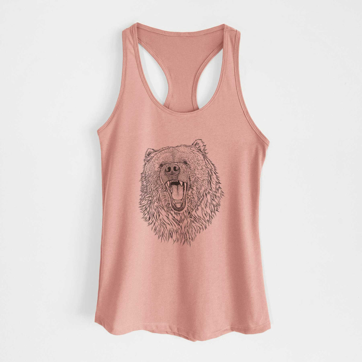 Desert pink women's racerback tank top laid flat, printed with a detailed black ink portrait of a roaring Kodiak bear facing forward.