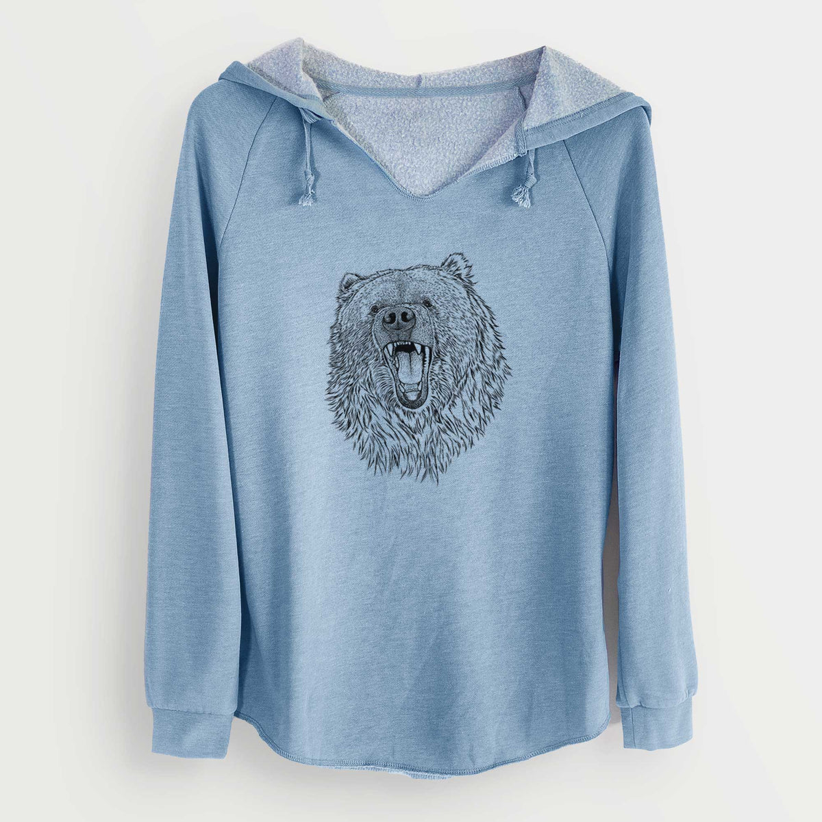 Misty blue women's Cali Wave hooded sweatshirt laid flat, printed with a detailed black ink portrait of a roaring Kodiak bear facing forward.