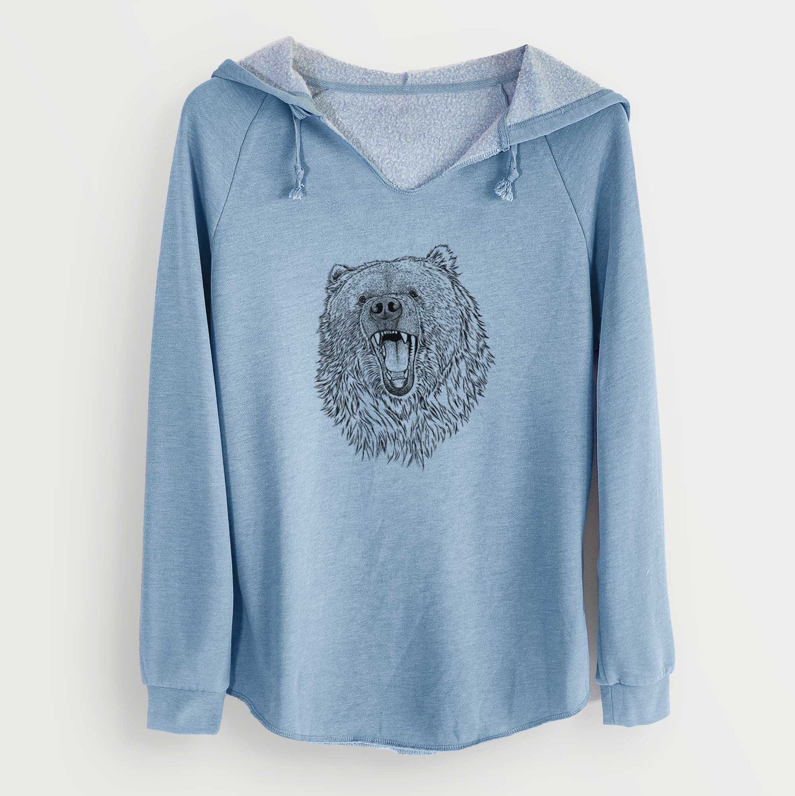 Misty blue women's Cali Wave hooded sweatshirt laid flat, printed with a detailed black ink portrait of a roaring Kodiak bear facing forward.