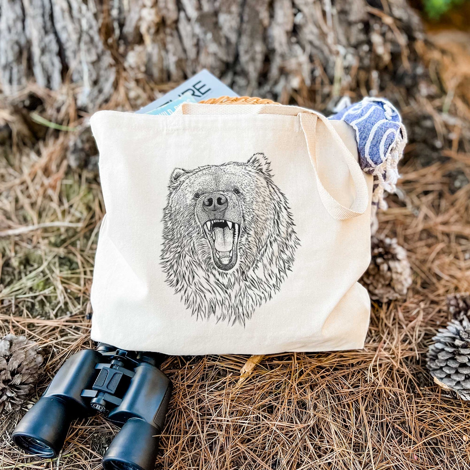Natural canvas tote bag printed with a detailed black ink portrait of a roaring Kodiak bear facing forward.