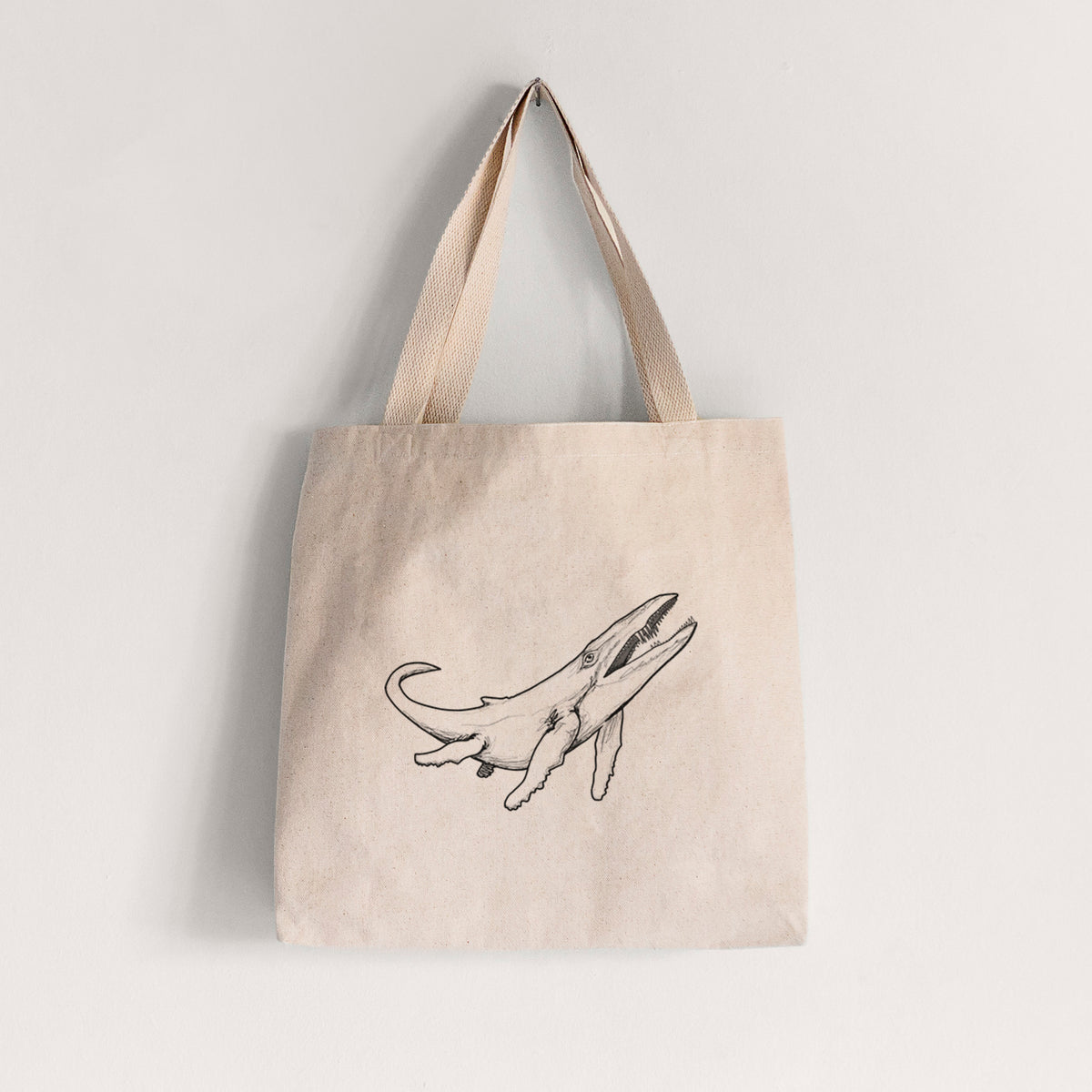 Natural canvas tote bag printed with a black ink illustration of a Kronosaurus marine reptile swimming.
