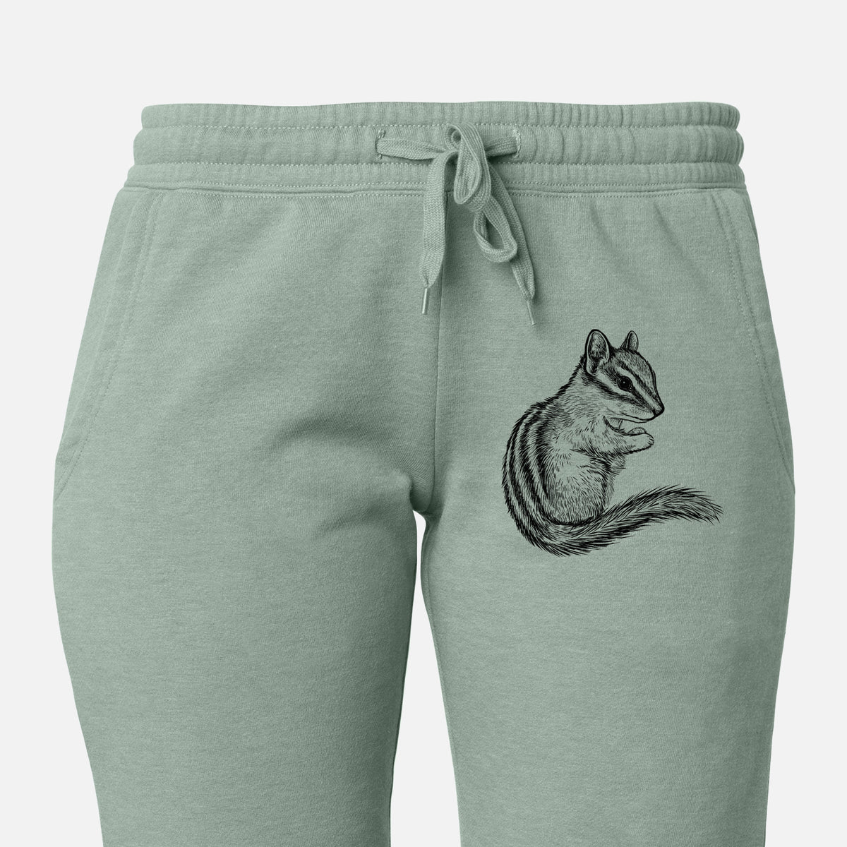 Front of sage green Cali Wave sweatpants, printed with a detailed black ink illustration of a least chipmunk sitting and holding food in its paws on the leg.