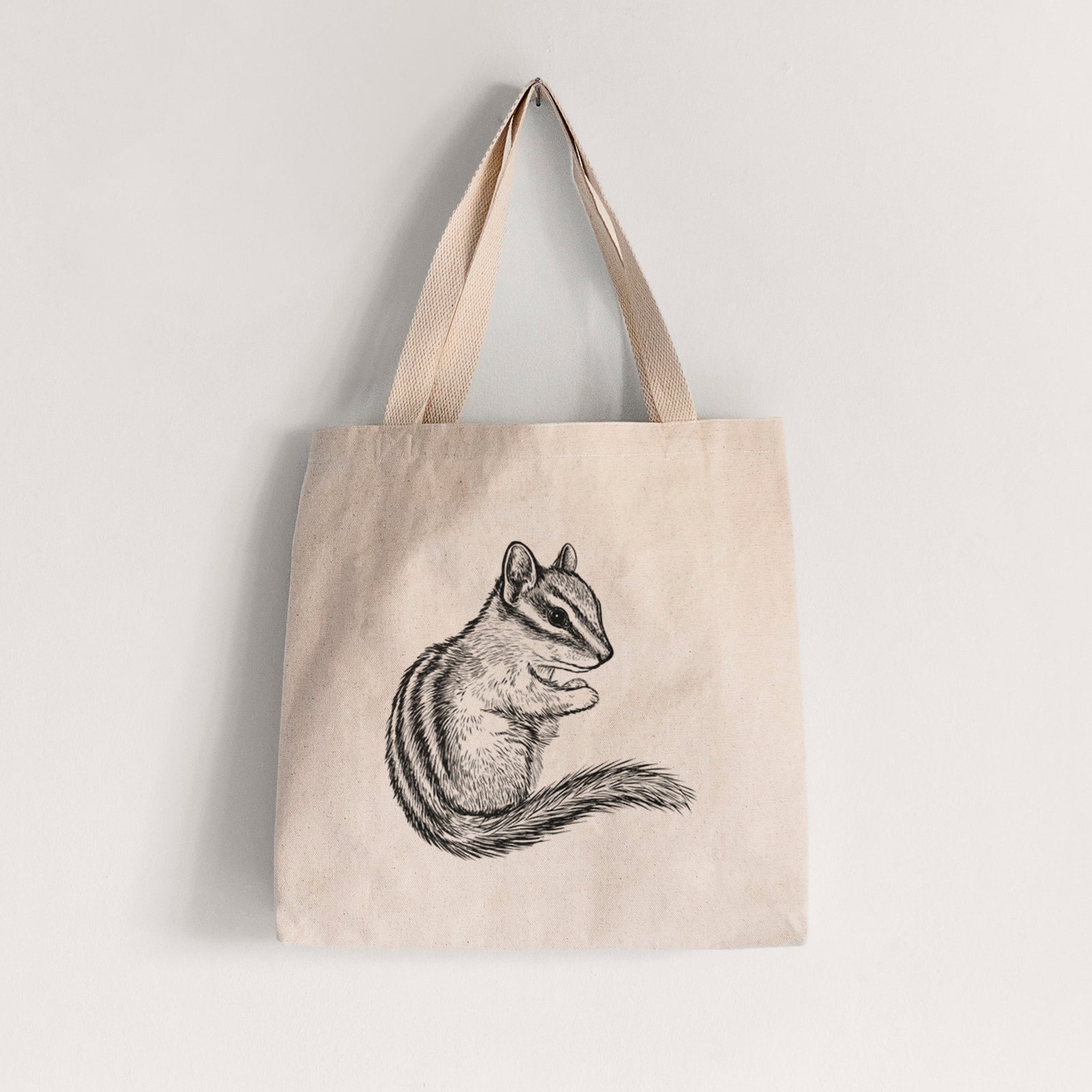 Natural canvas tote bag printed with a detailed black ink illustration of a least chipmunk sitting and holding food in its paws.
