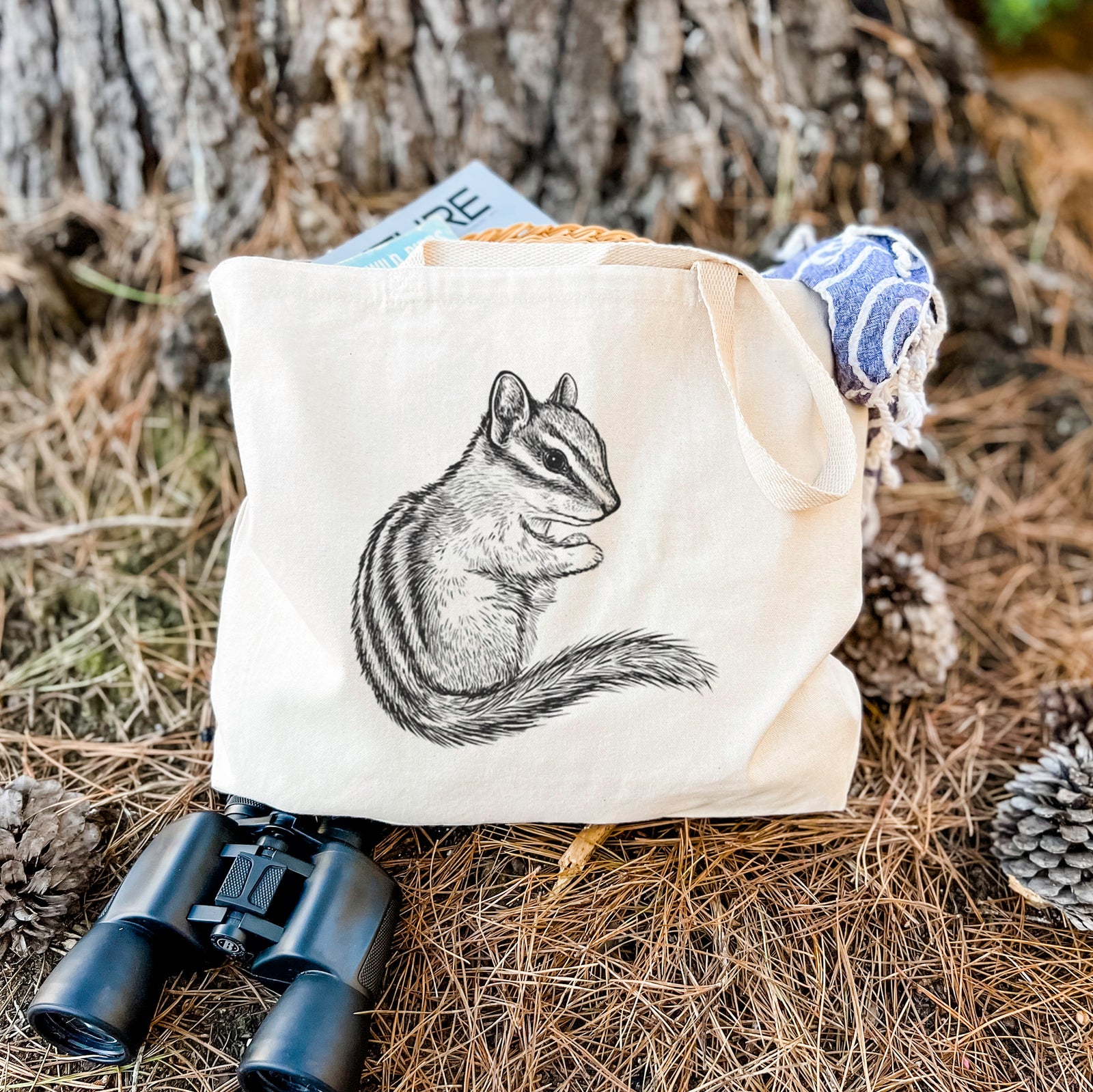 Natural canvas tote bag printed with a detailed black ink illustration of a least chipmunk sitting and holding food in its paws.