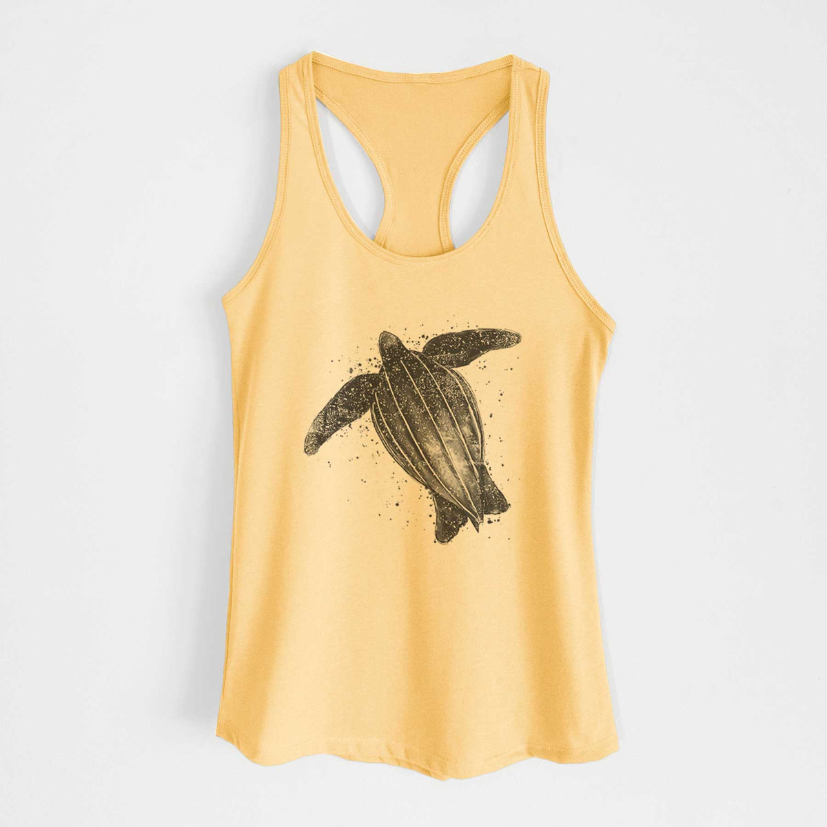 Banana cream women's racerback tank top laid flat, printed with a black ink illustration of a leatherback sea turtle swimming, with ink splatters.