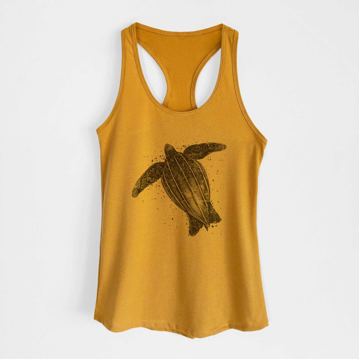 Gold women's racerback tank top laid flat, printed with a black ink illustration of a leatherback sea turtle swimming, with ink splatters.