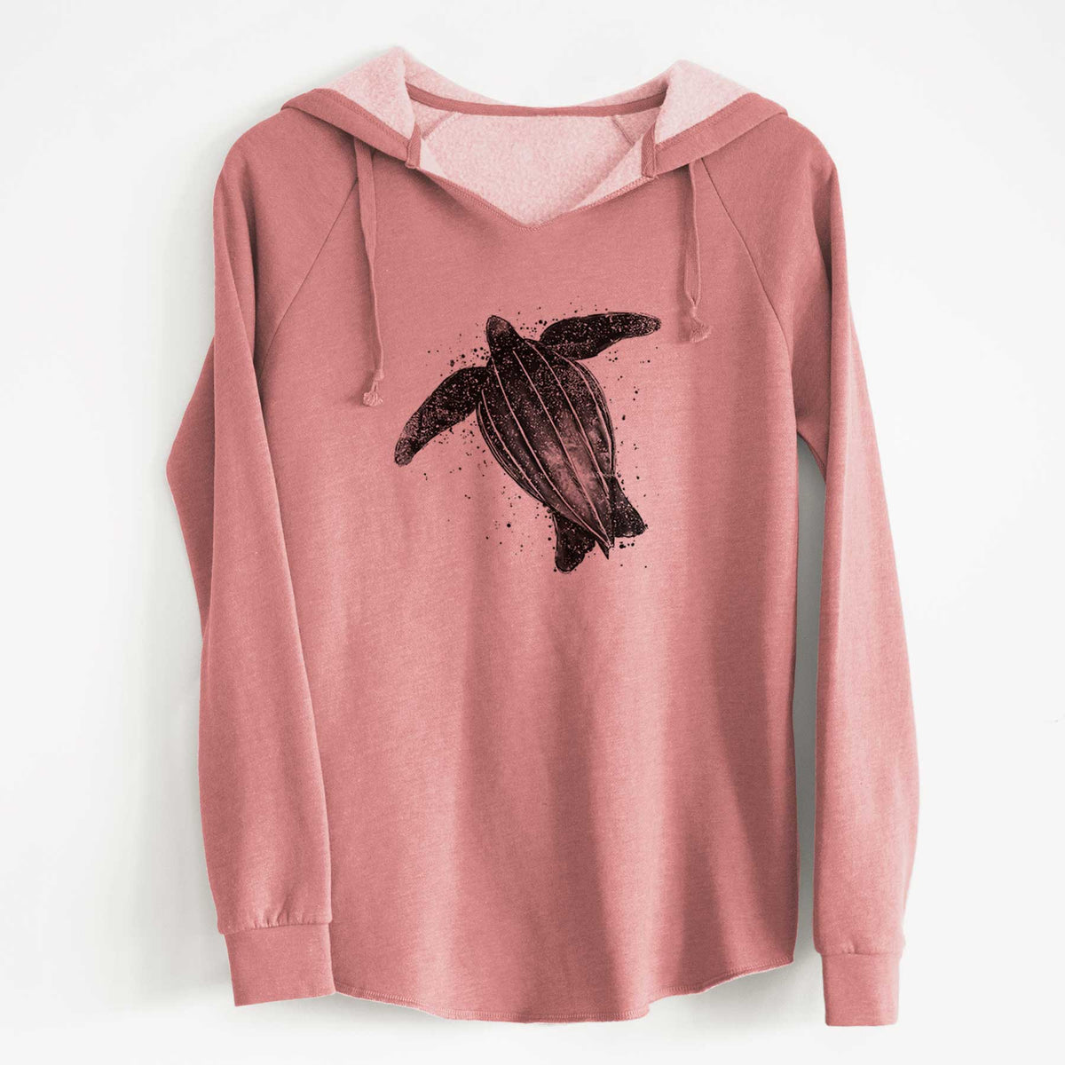 Dusty rose women's Cali Wave hooded sweatshirt laid flat, printed with a black ink illustration of a leatherback sea turtle swimming, with ink splatters.
