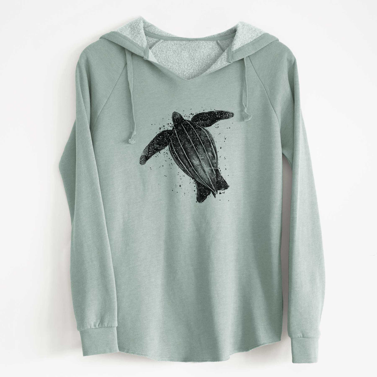 Sage green women's Cali Wave hooded sweatshirt laid flat, printed with a black ink illustration of a leatherback sea turtle swimming, with ink splatters.