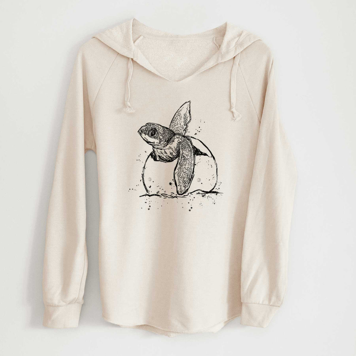 Bone cream women's Cali Wave hooded sweatshirt laid flat, printed with a black ink illustration of a leatherback sea turtle hatchling emerging from its egg.
