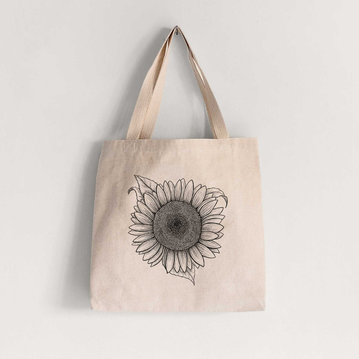 Natural canvas tote bag printed with a detailed black ink line drawing of a Lemon Queen sunflower in bloom.