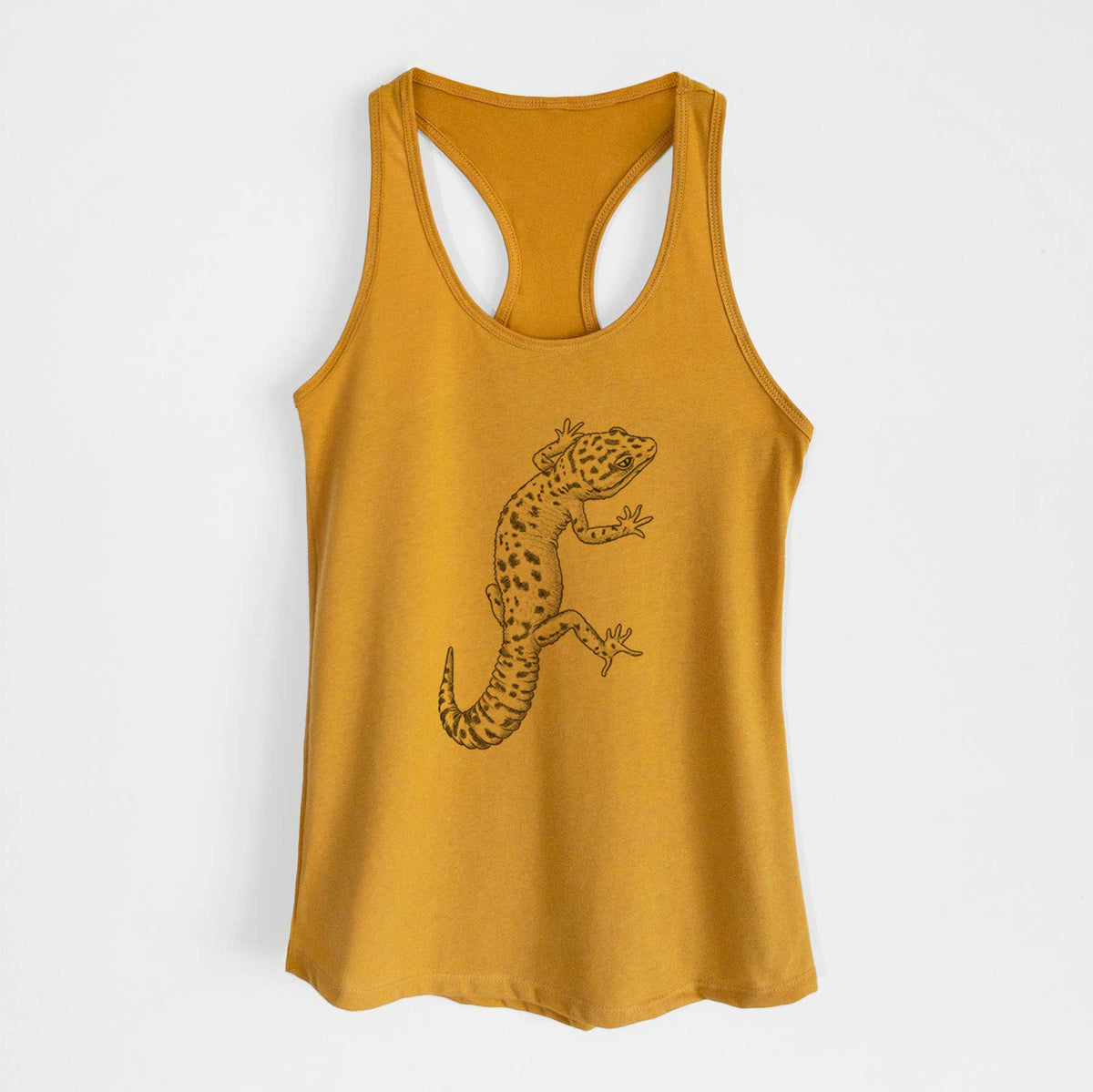 Gold women's racerback tank top laid flat, printed with a detailed black ink illustration of a spotted leopard gecko climbing.