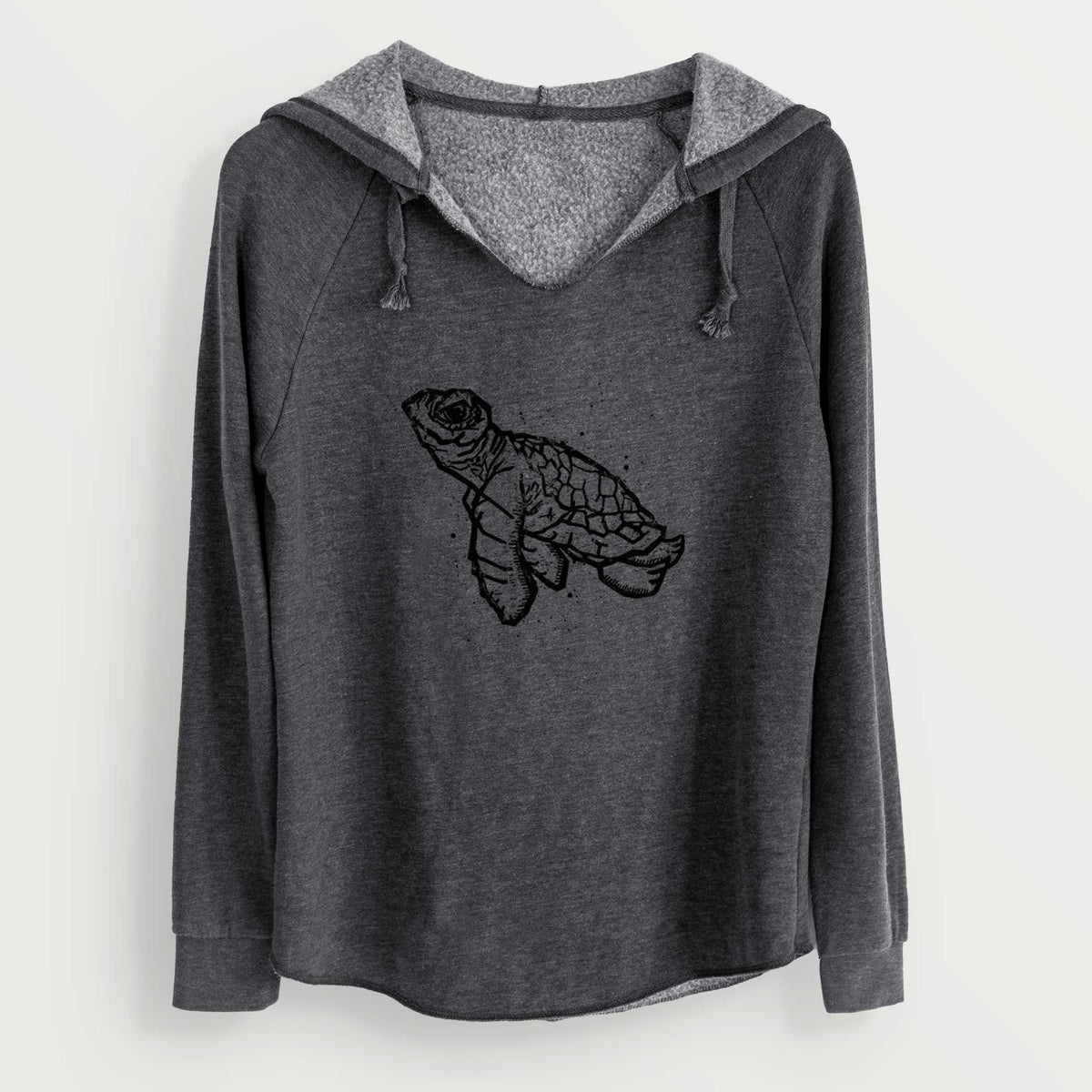 Charcoal grey women's Cali Wave hooded sweatshirt laid flat, printed with a black linocut-style illustration of a baby sea turtle with a patterned shell and ink splatters.