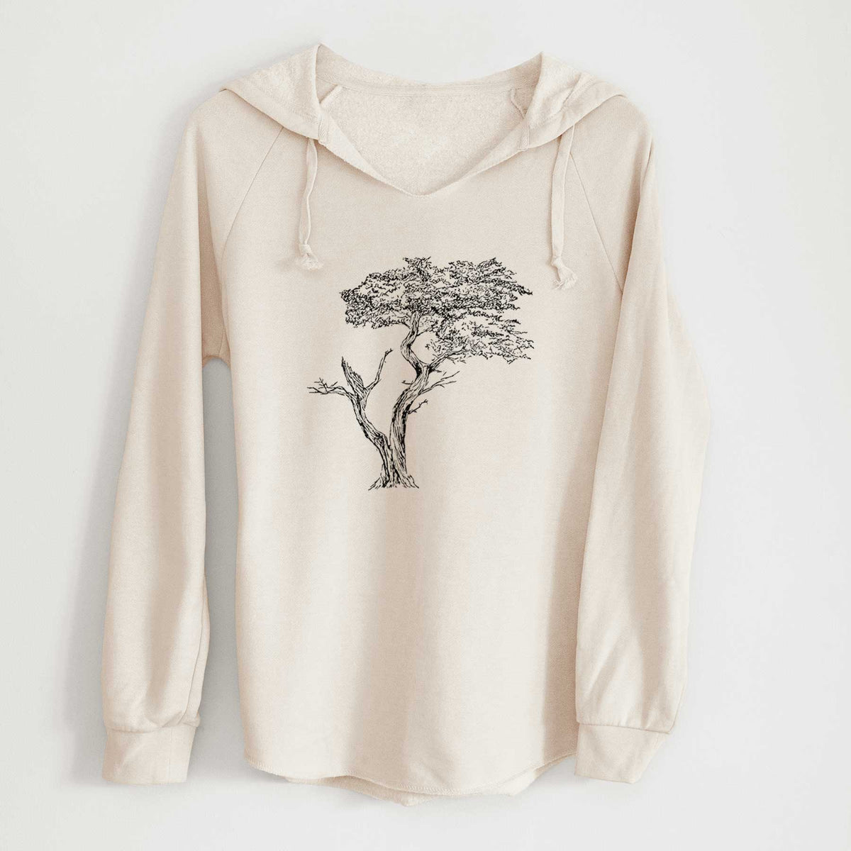 Bone cream women's Cali Wave hooded sweatshirt laid flat, printed with a black ink illustration of the windswept Lone Cypress tree on a rocky outcrop.
