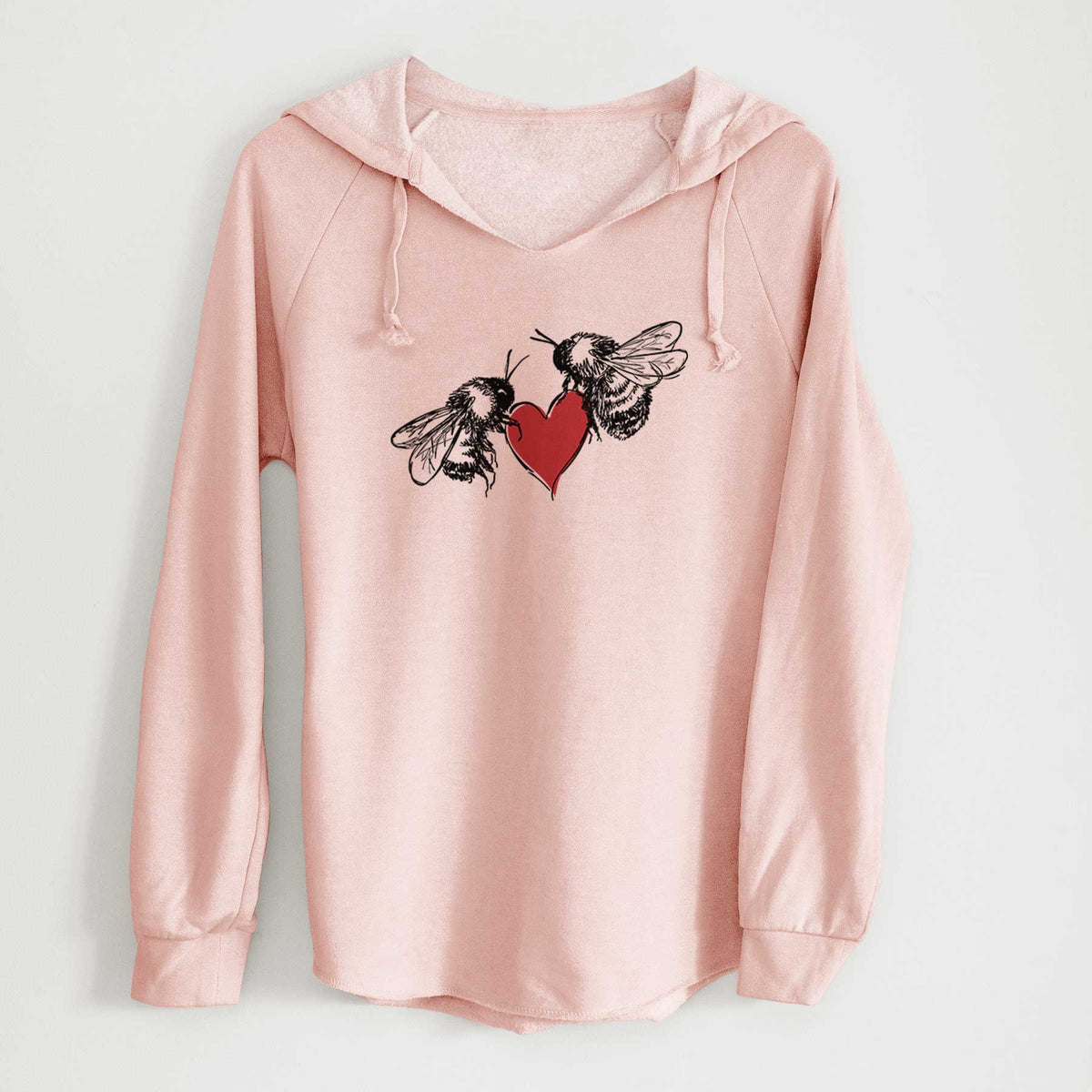 Blush pink women's Cali Wave hooded sweatshirt laid flat, printed with a black ink illustration of two bees facing each other with a red heart between them.