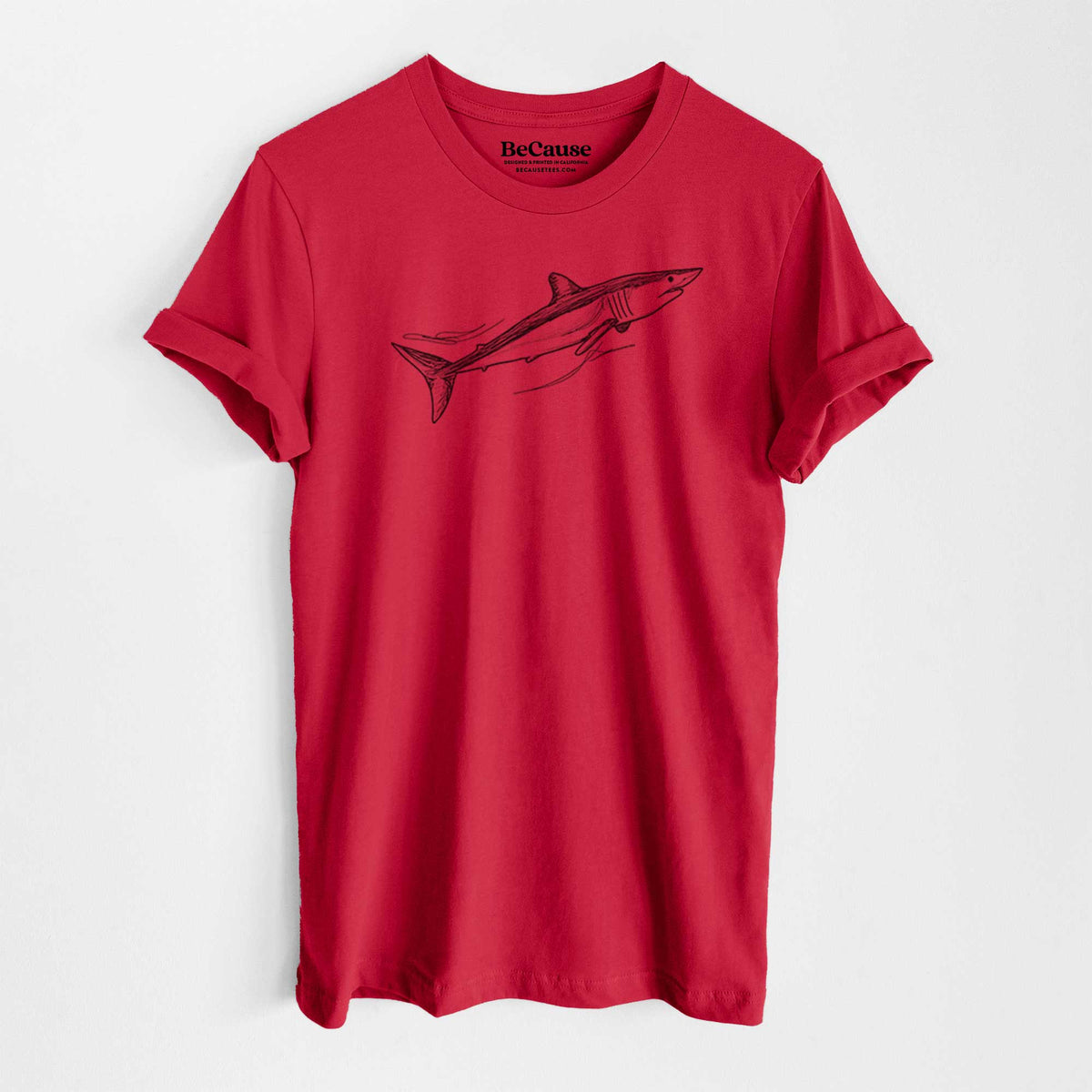 Ruby red lightweight cotton t-shirt laid flat, printed with a black ink illustration of a mako shark swimming.