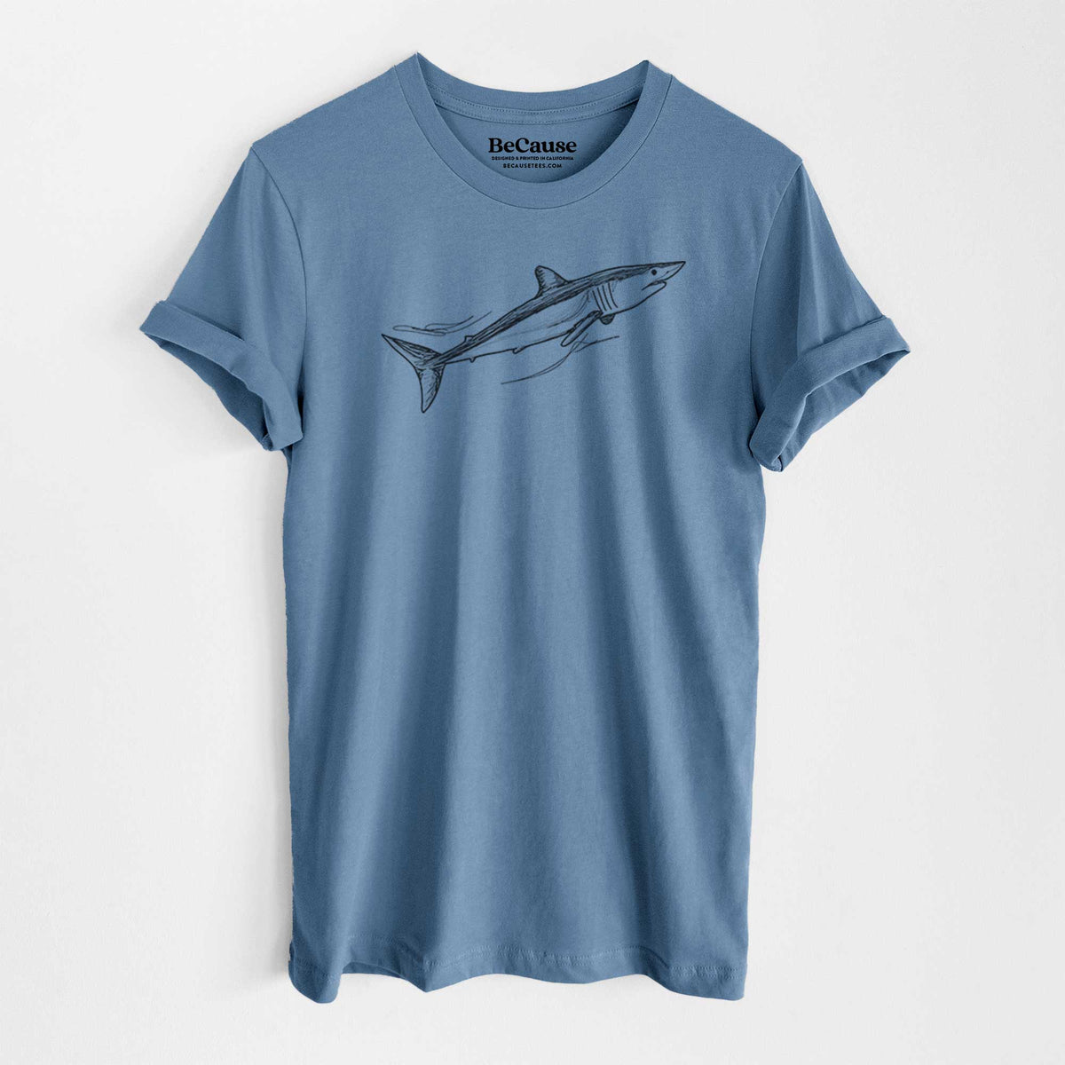 Steel blue lightweight cotton t-shirt laid flat, printed with a black ink illustration of a mako shark swimming.