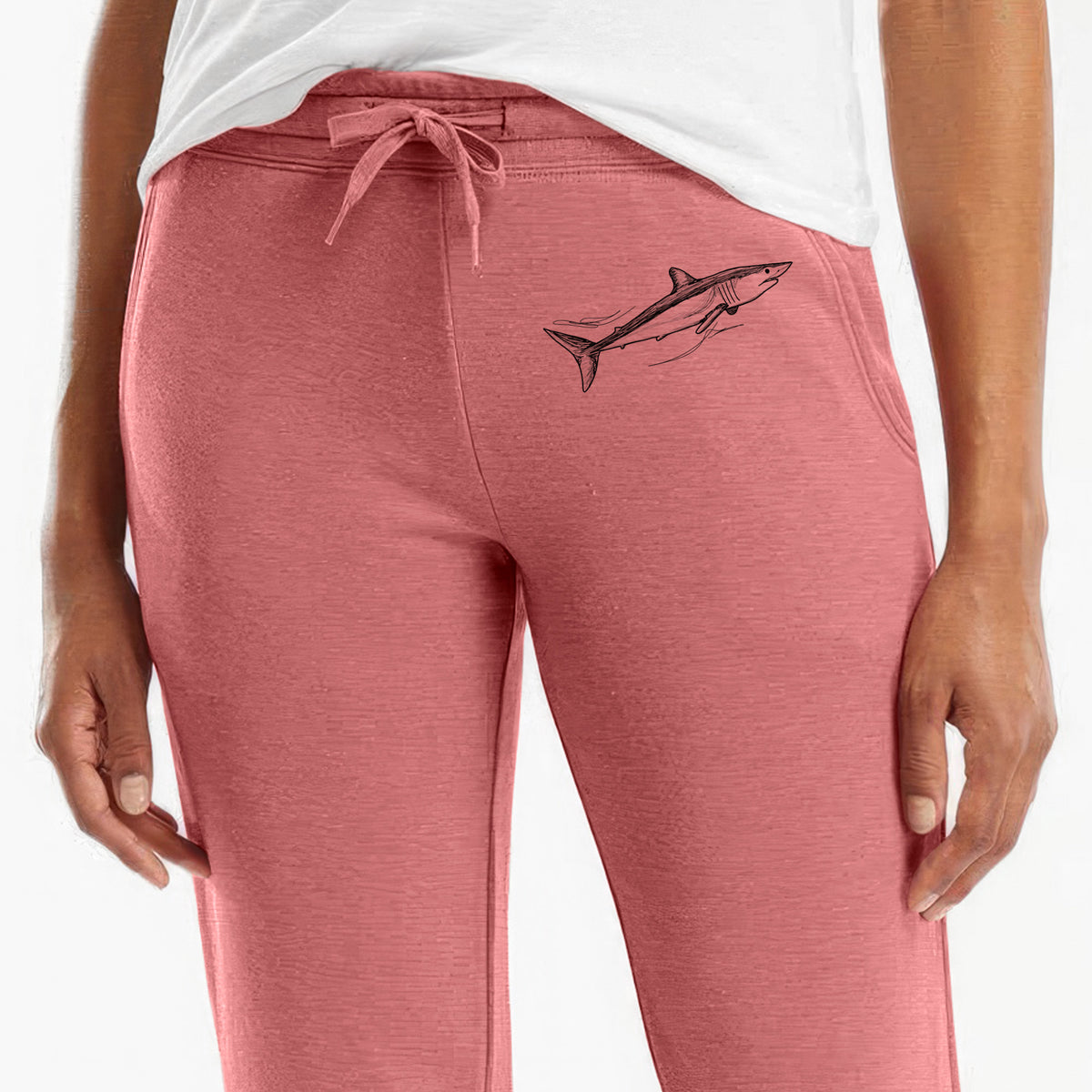Front of dusty rose Cali Wave sweatpants, printed with a black ink illustration of a mako shark swimming on the leg.