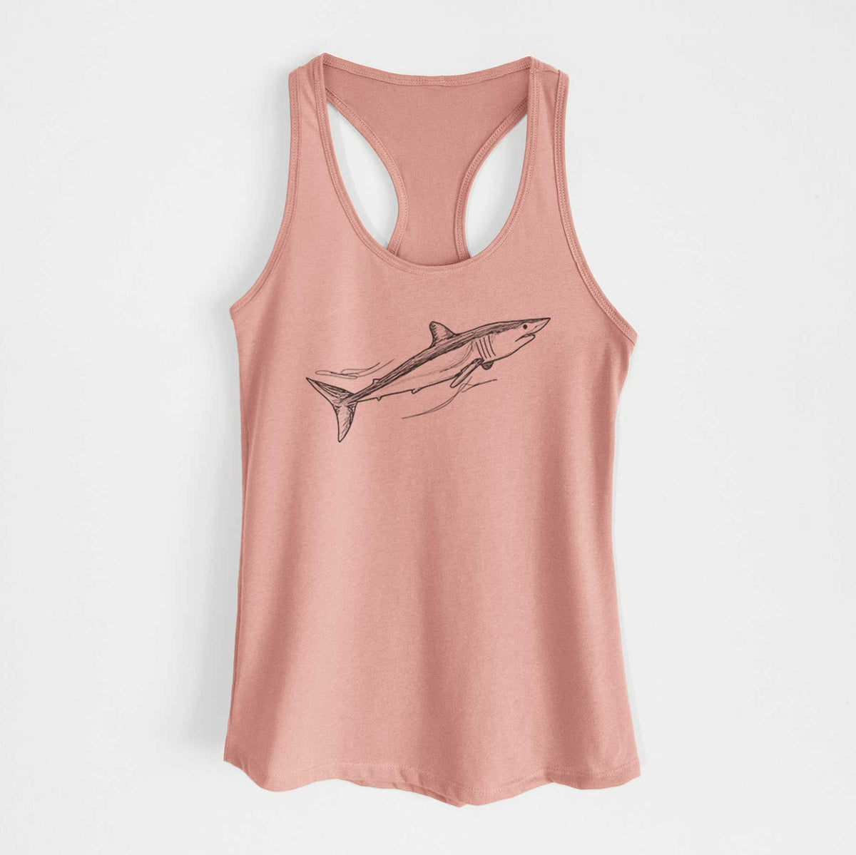 Desert pink women's racerback tank top laid flat, printed with a black ink illustration of a mako shark swimming.