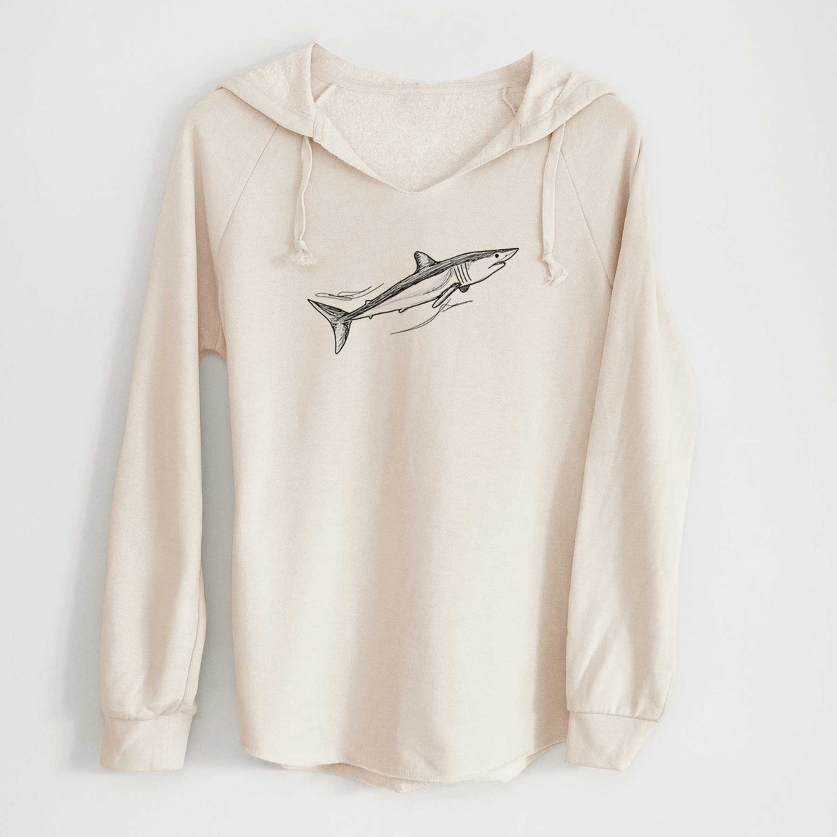 Bone cream women's Cali Wave hooded sweatshirt laid flat, printed with a black ink illustration of a mako shark swimming.