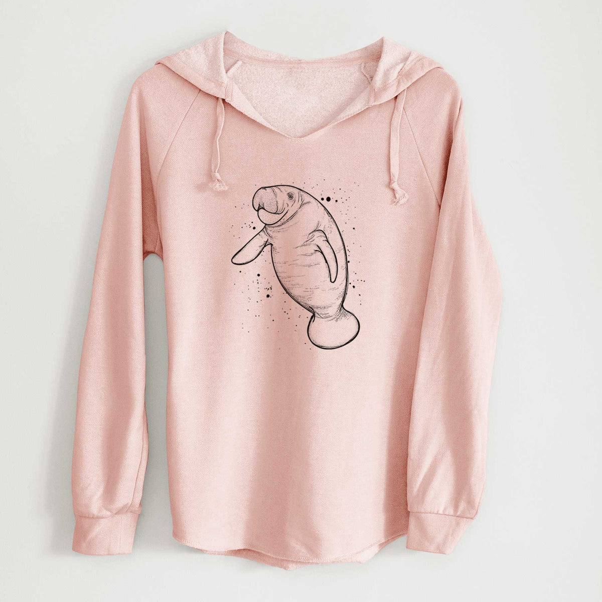 Blush pink women's Cali Wave hooded sweatshirt laid flat, printed with a black ink line drawing of a manatee swimming, with ink splatters.
