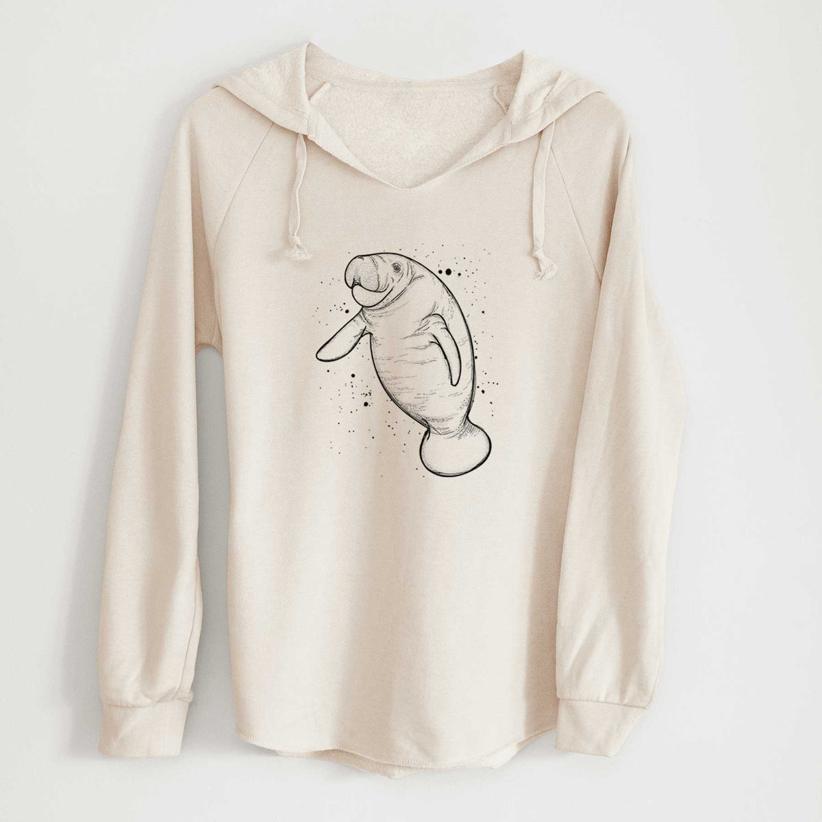 Bone cream women's Cali Wave hooded sweatshirt laid flat, printed with a black ink line drawing of a manatee swimming, with ink splatters.