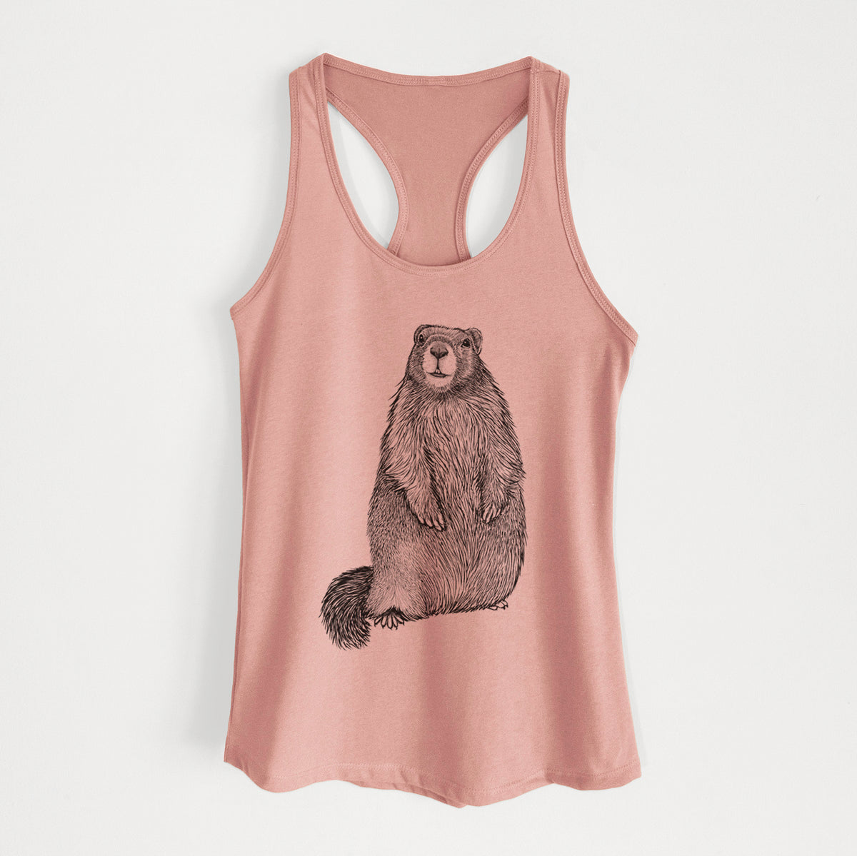 Desert pink women's racerback tank top laid flat, printed with a detailed black ink illustration of a marmot standing upright.