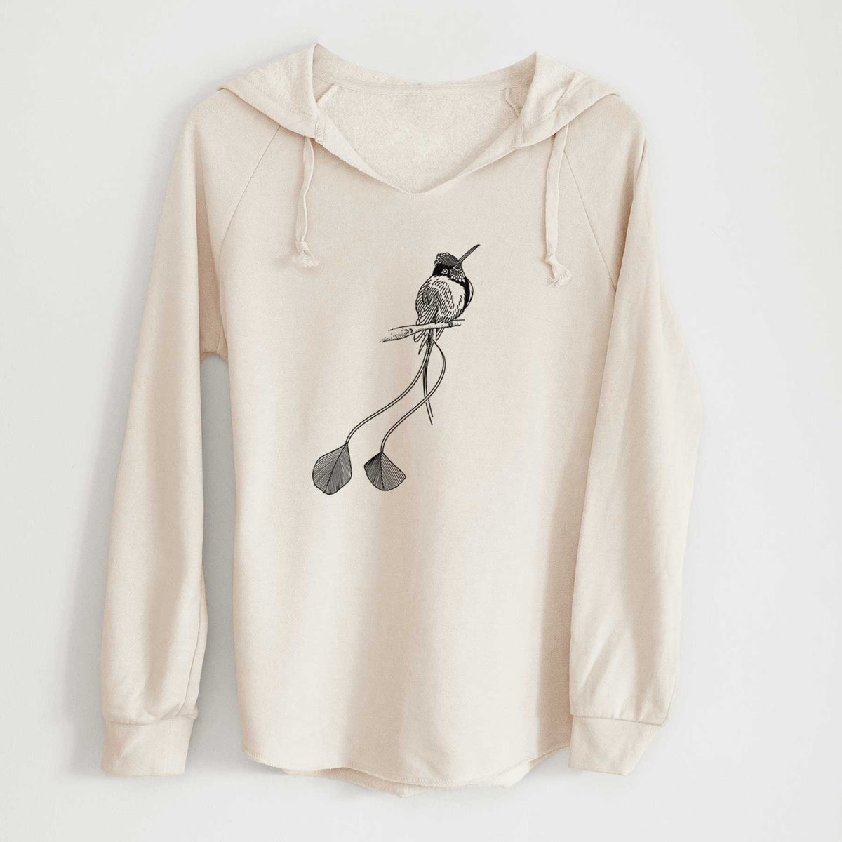 Bone cream women's Cali Wave hooded sweatshirt laid flat, printed with a black ink illustration of a marvelous spatuletail hummingbird perched, with its two long racket-tipped tail feathers.