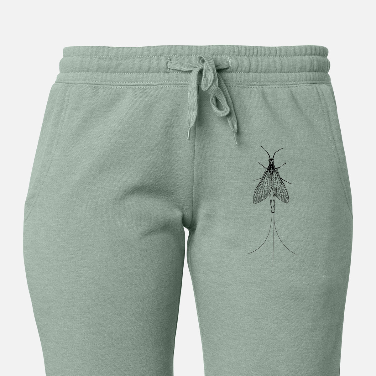 Front of sage green Cali Wave sweatpants, printed with a detailed black ink illustration of a mayfly with its wings raised and long tail filaments on the leg.
