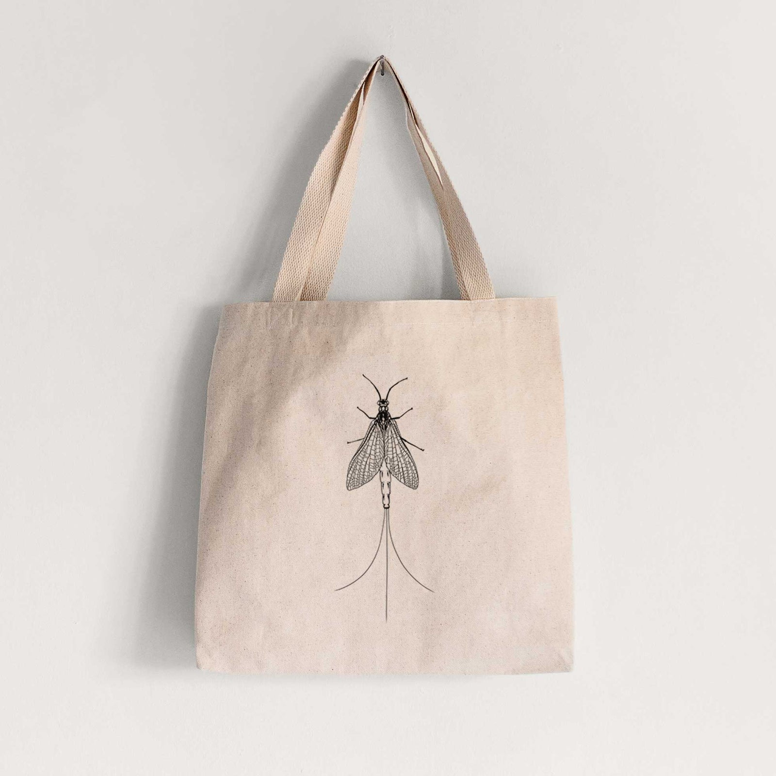 Natural canvas tote bag printed with a detailed black ink illustration of a mayfly with its wings raised and long tail filaments.