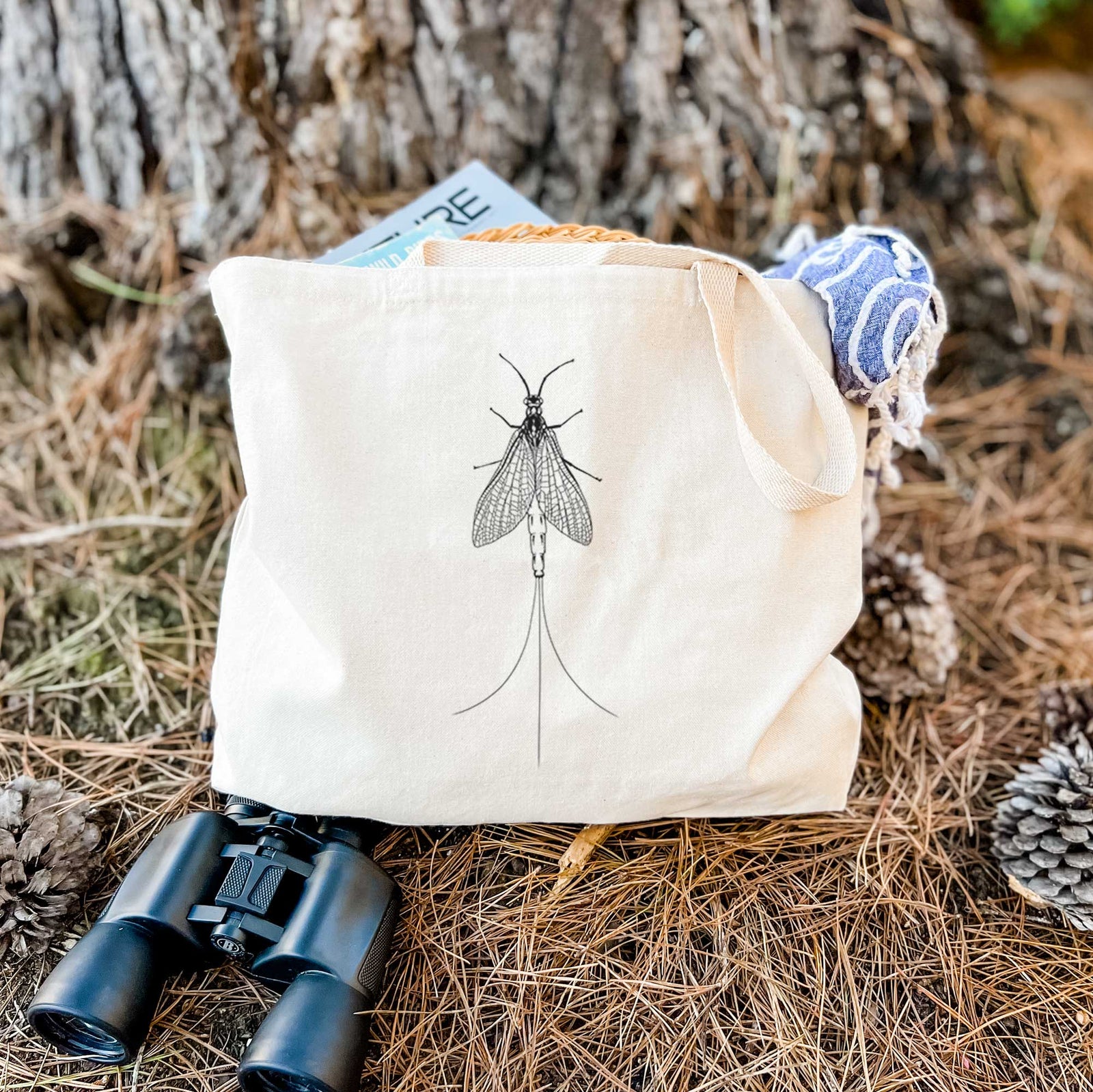 Natural canvas tote bag printed with a detailed black ink illustration of a mayfly with its wings raised and long tail filaments.