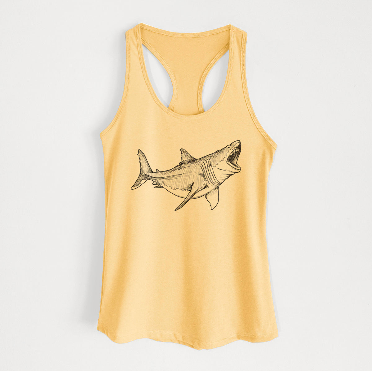 Banana cream women's racerback tank top laid flat, printed with a black ink illustration of a megalodon shark with its jaws open.