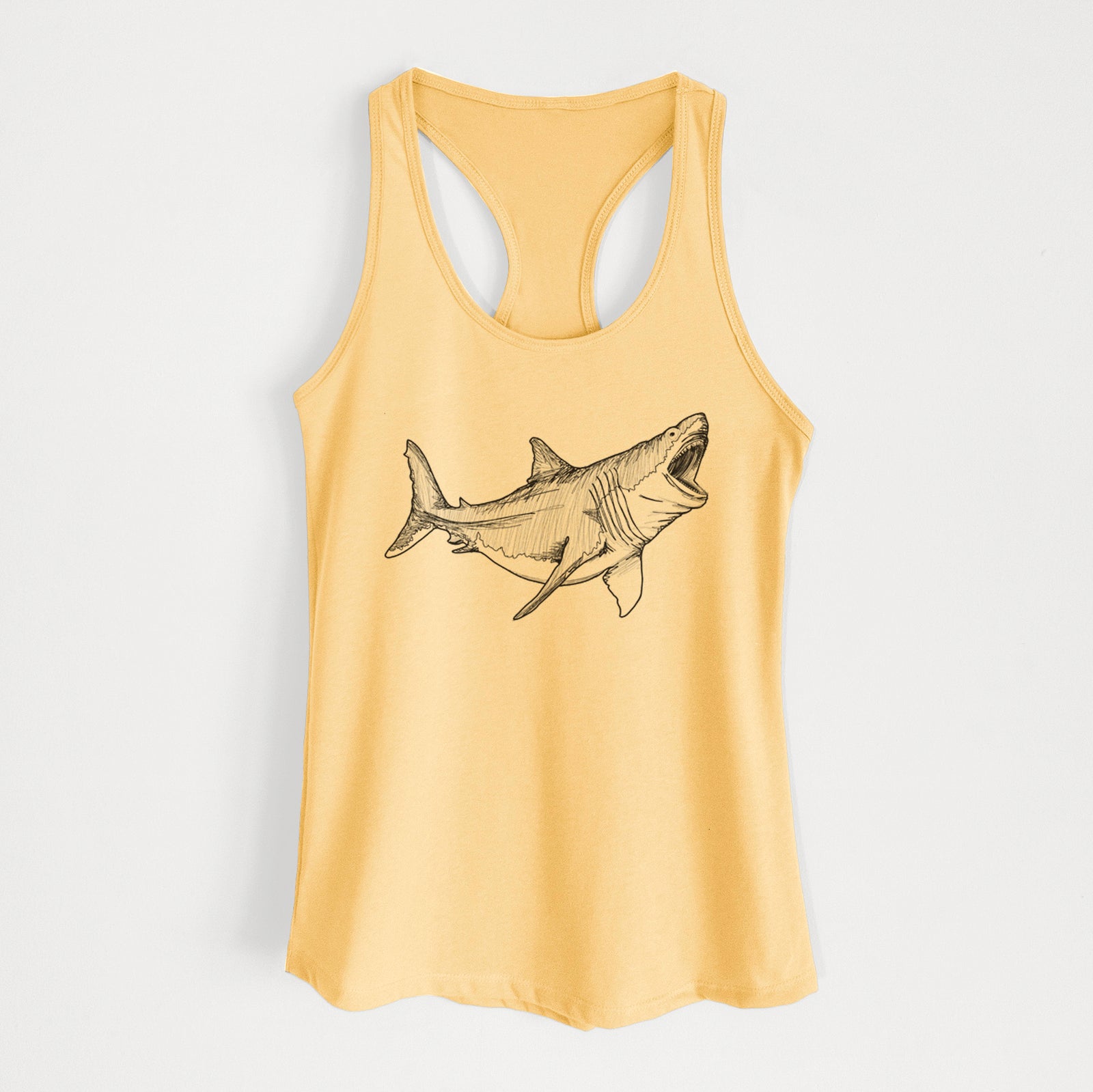 Banana cream women's racerback tank top laid flat, printed with a black ink illustration of a megalodon shark with its jaws open.