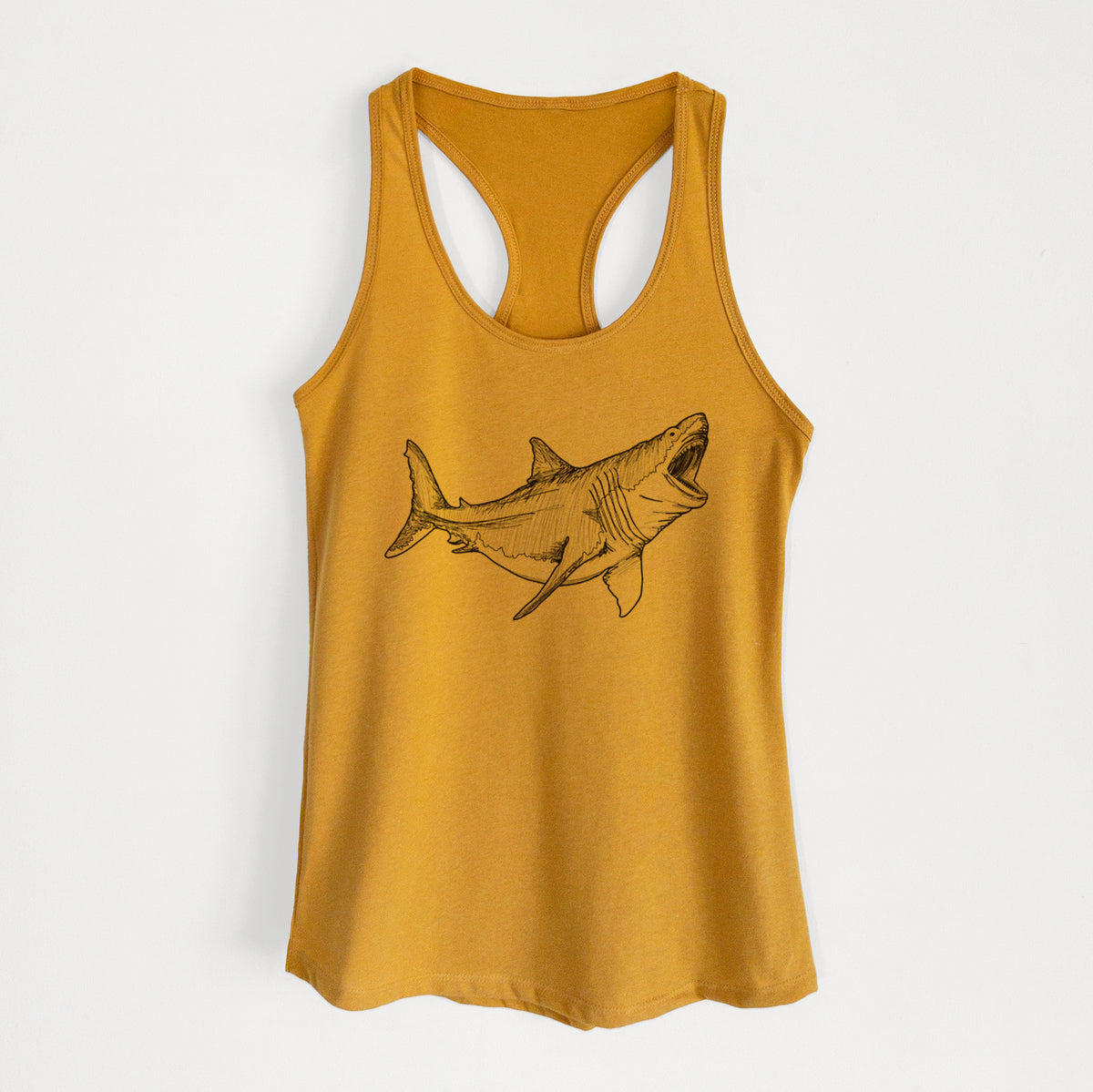 Gold women's racerback tank top laid flat, printed with a black ink illustration of a megalodon shark with its jaws open.
