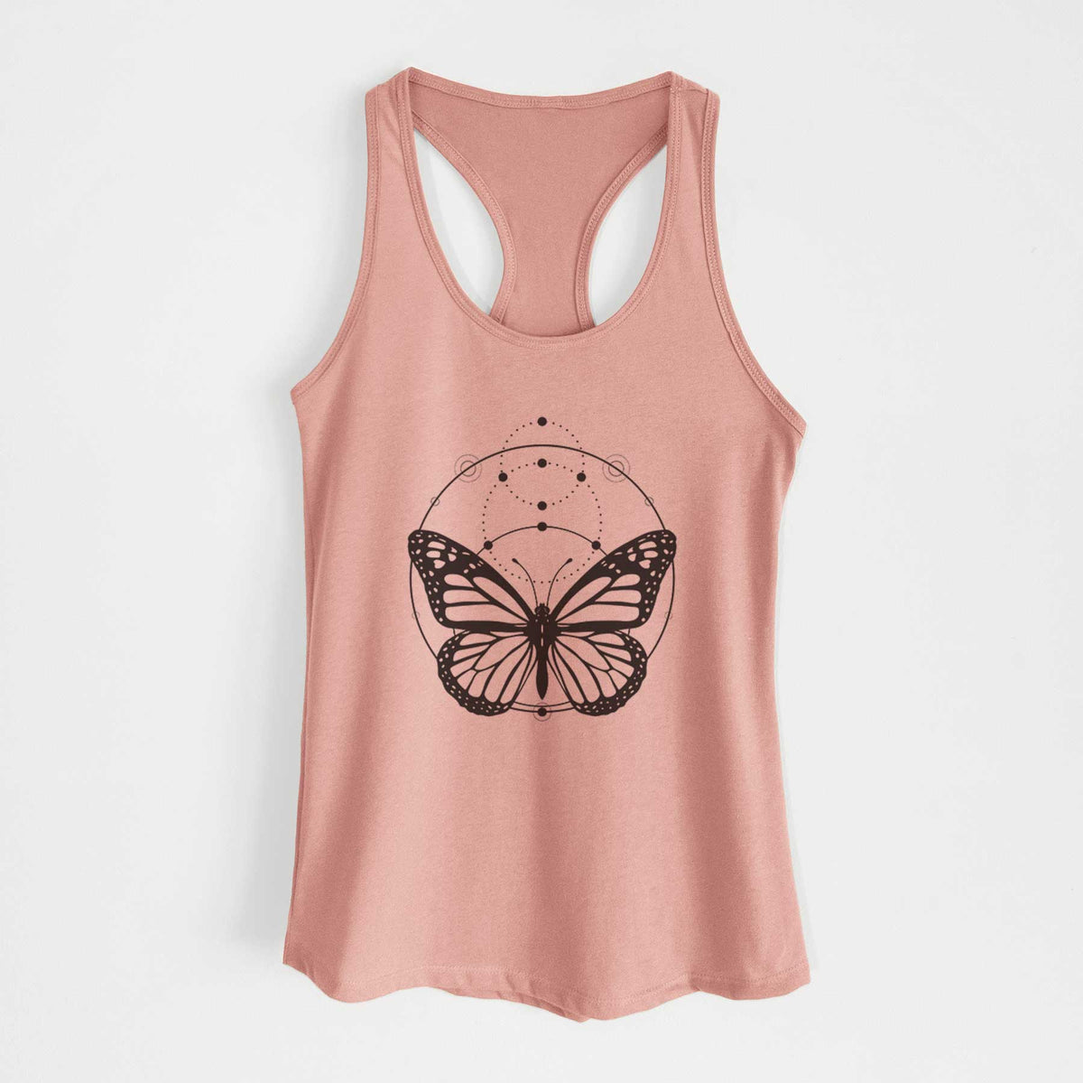 Desert pink women's racerback tank top laid flat, printed with a black ink monarch butterfly inside a circle, beneath a line of moon phases.