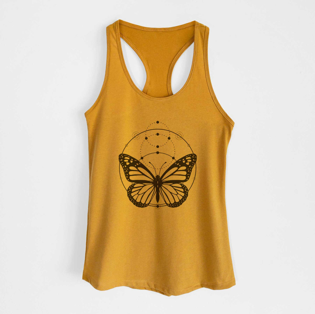 Gold women's racerback tank top laid flat, printed with a black ink monarch butterfly inside a circle, beneath a line of moon phases.