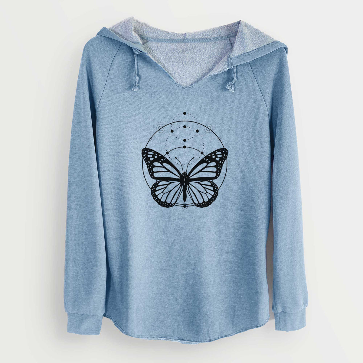 Misty blue women's Cali Wave hooded sweatshirt laid flat, printed with a black ink monarch butterfly inside a circle, beneath a line of moon phases.