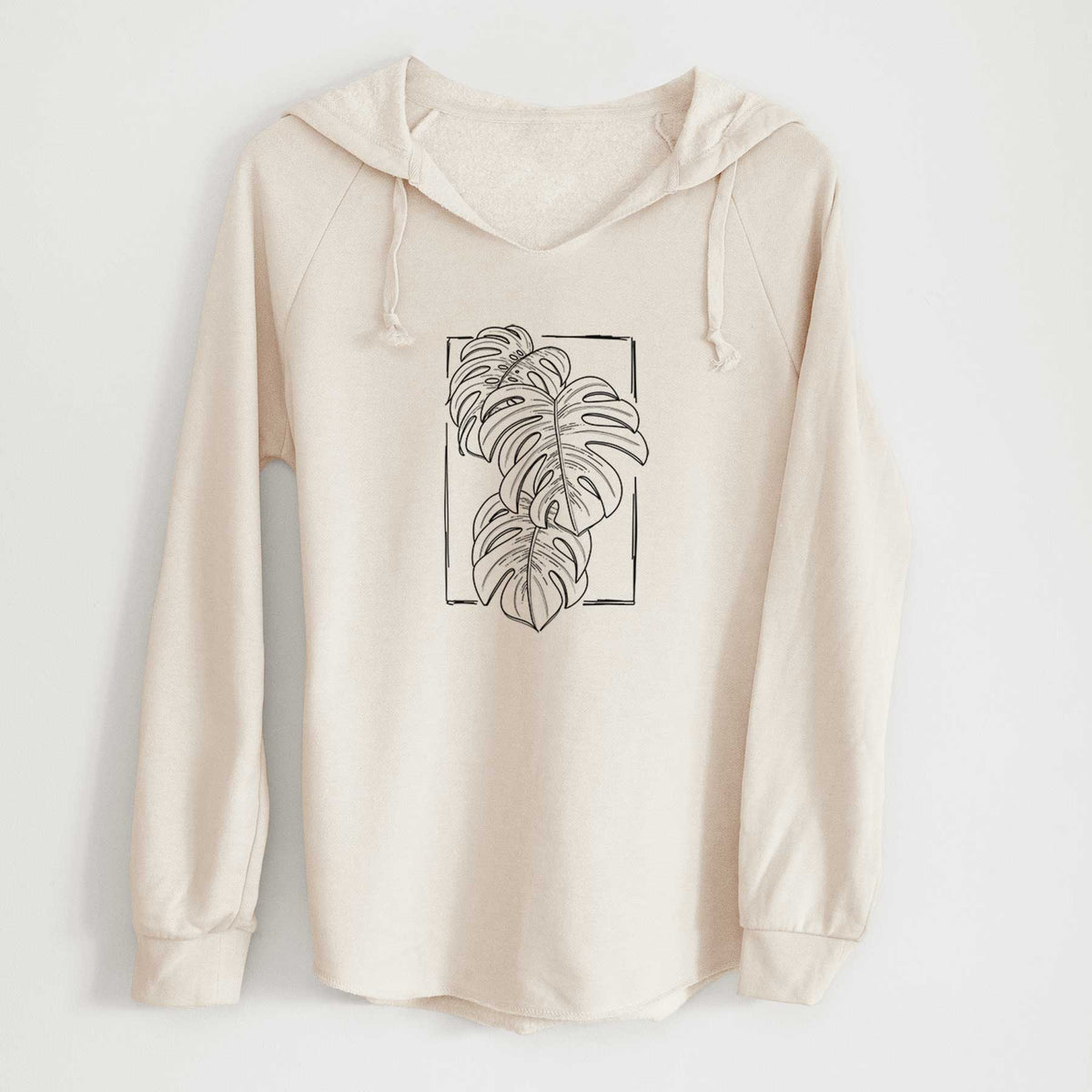 Bone cream women's Cali Wave hooded sweatshirt laid flat, printed with a black ink line drawing of Monstera deliciosa leaves inside a rectangle outline.