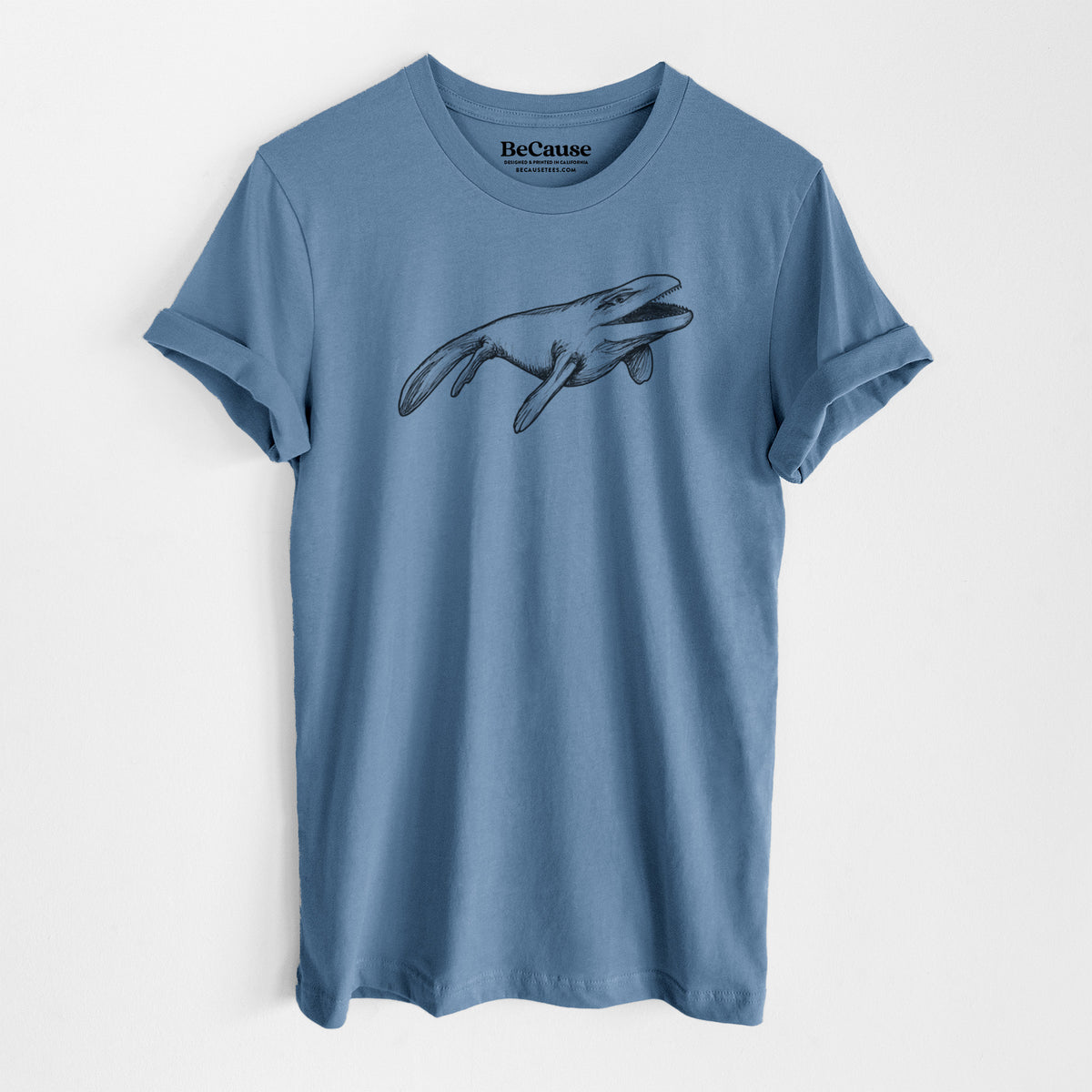 Steel blue lightweight cotton t-shirt laid flat, printed with a black ink illustration of a Mosasaur swimming.